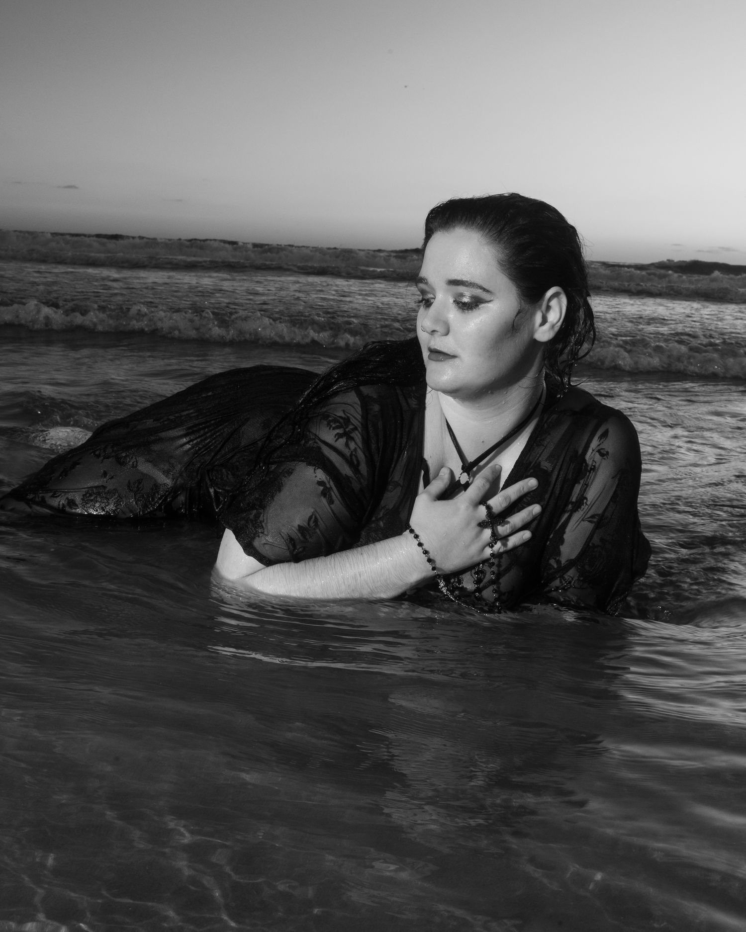 Artistic black and white photo sequence of a person submerged in water.