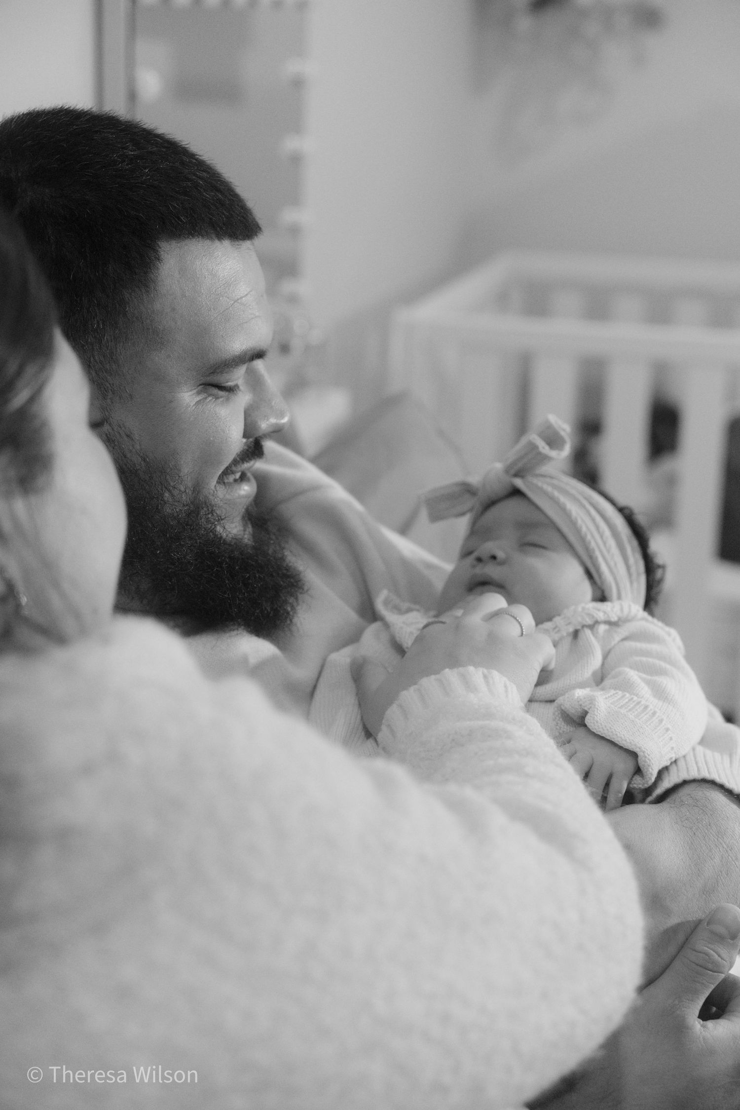Black and white intimate newborn photography session with baby.