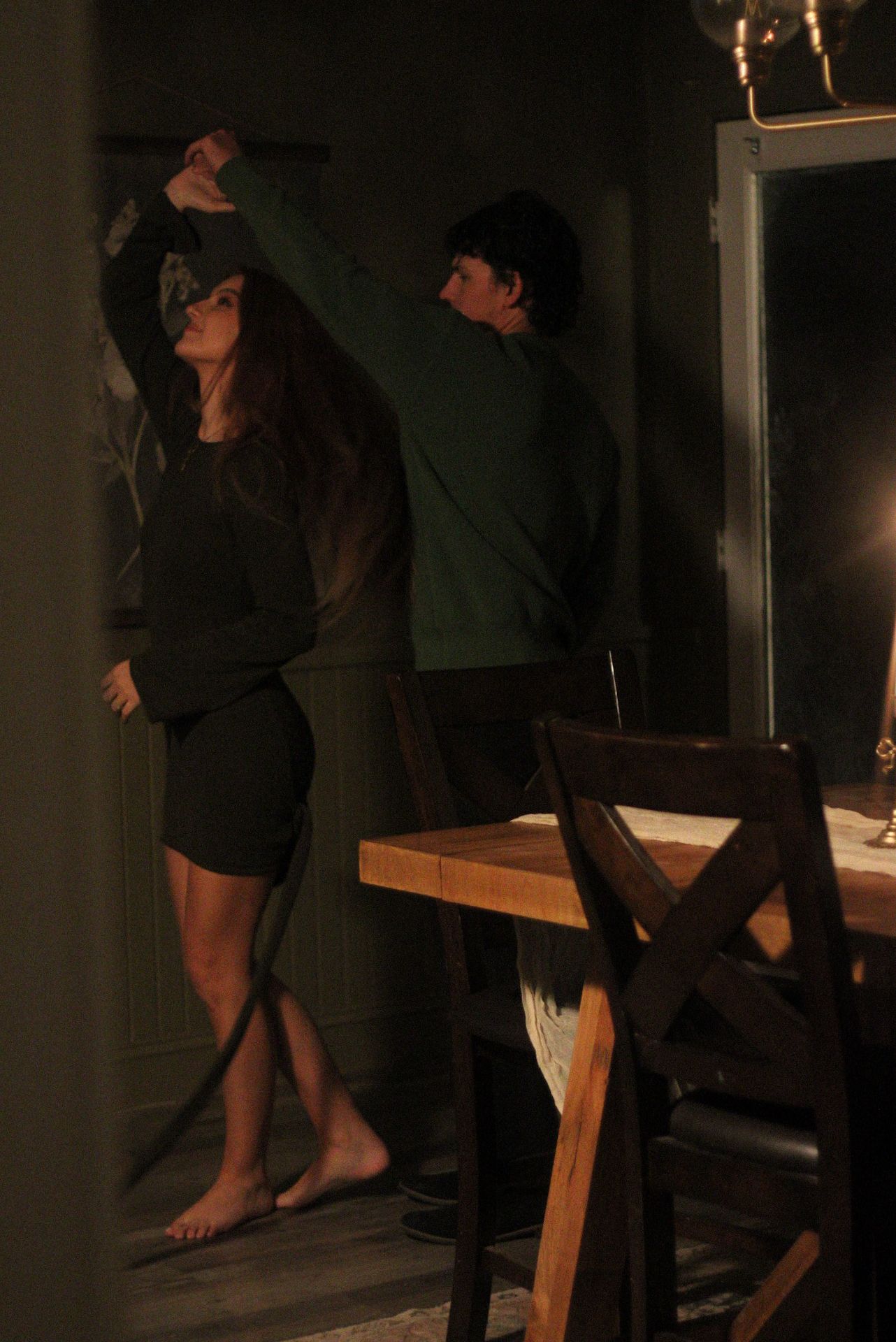 A dramatic low-light scene showing two people in an intimate dance pose.
