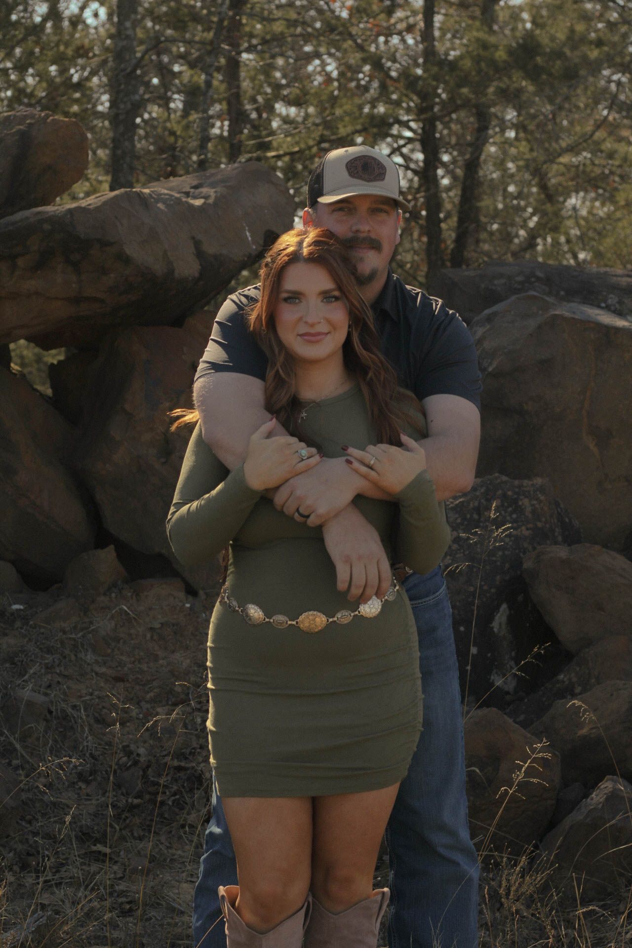 Intimate outdoor portrait session near rocky formations at sunset.