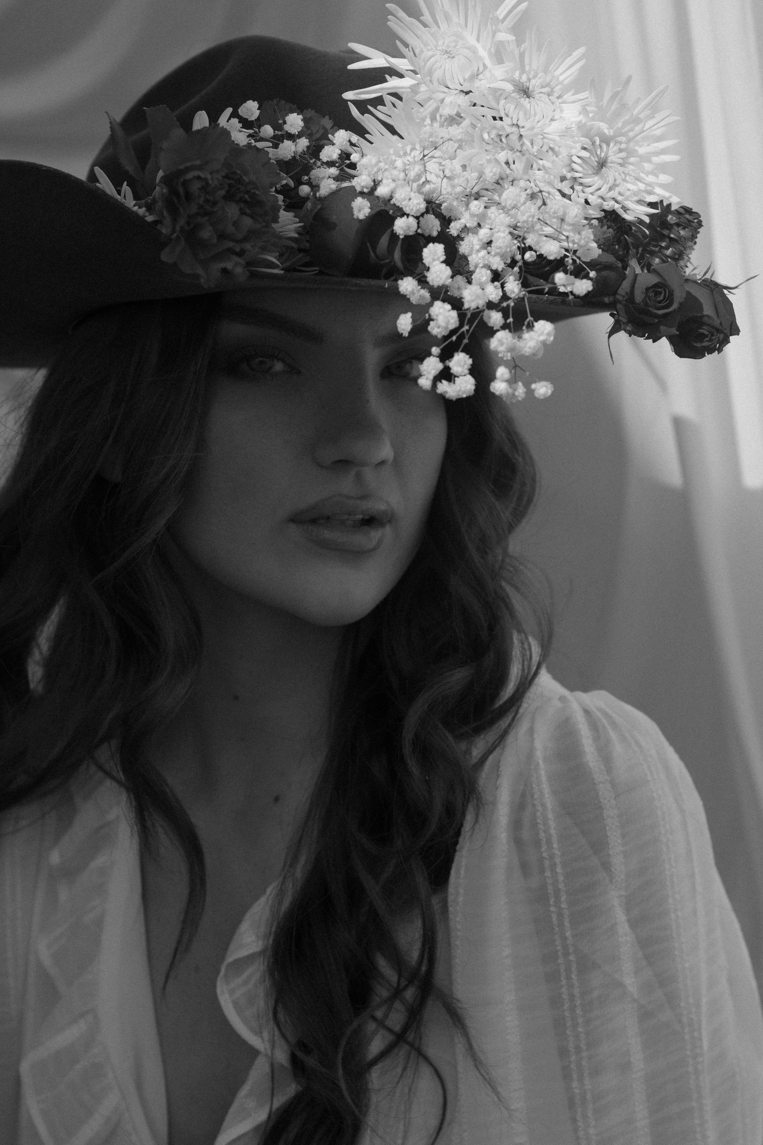 Black and white portrait series showing delicate floral crown with white blooms against soft natural light.