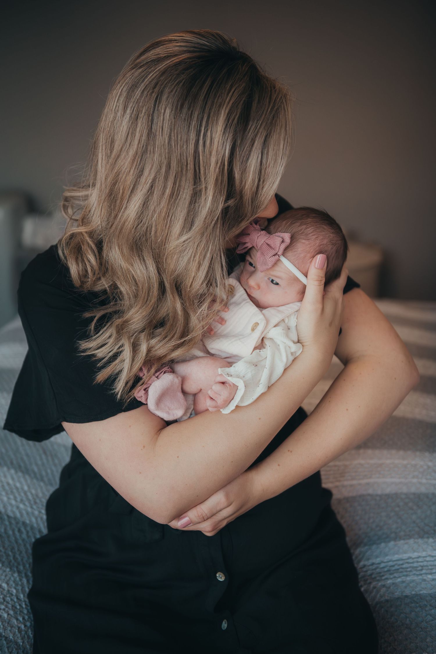 Intimate lifestyle newborn photography session showing tender parent moments.