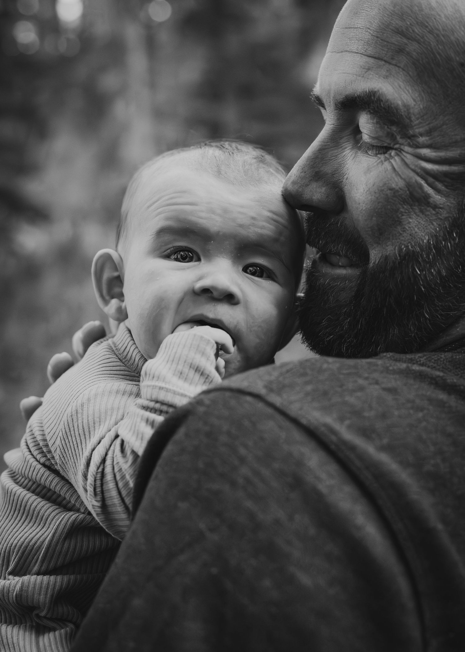 Intimate black and white portrait of parent and child embracing for family photos in Calgary, AB.