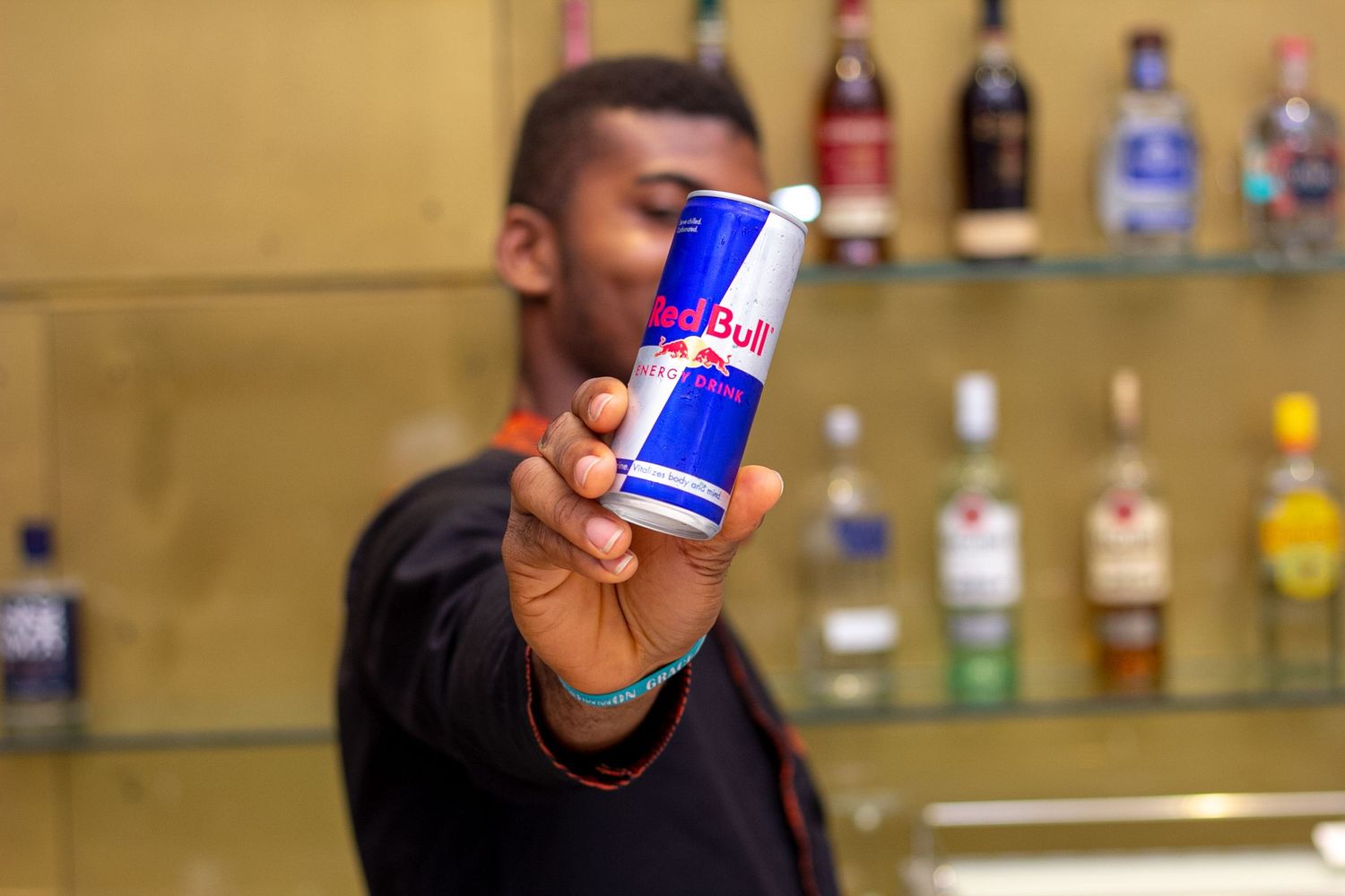 Redbull product shoot with a bartender holding the can of Redbull to the camera