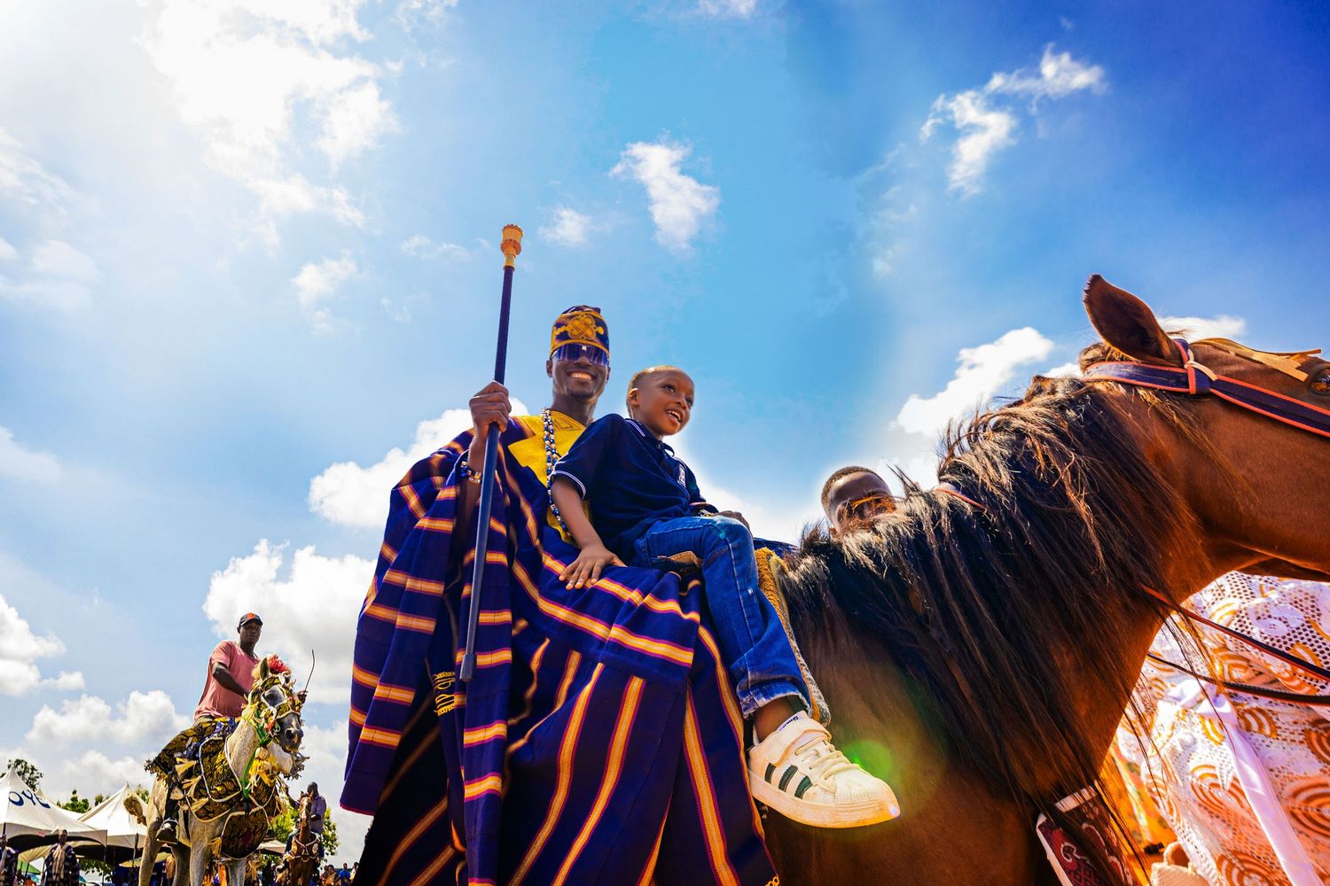A representative of an Epe Community riding on a horse back in style with young boy at the Ojude Oba Epe 2025