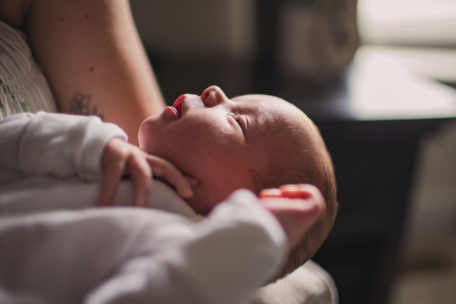 The up-close profile of a sleeping newborn baby.