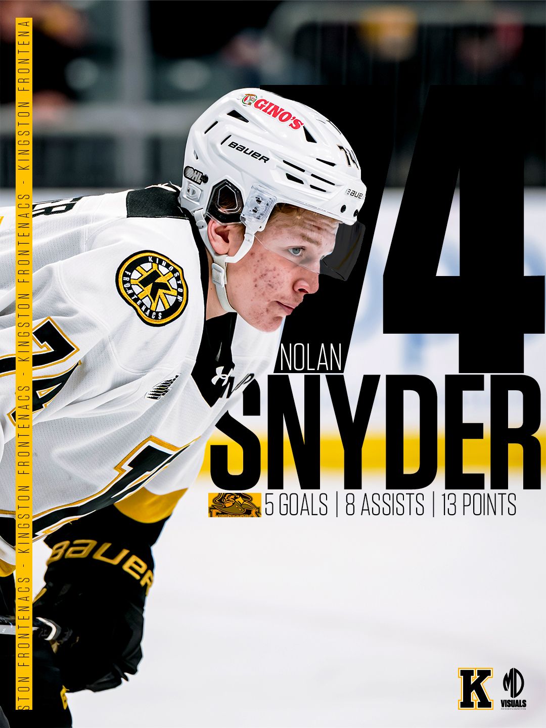 Hockey player in white Boston Bruins jersey skating on ice during professional NHL game.