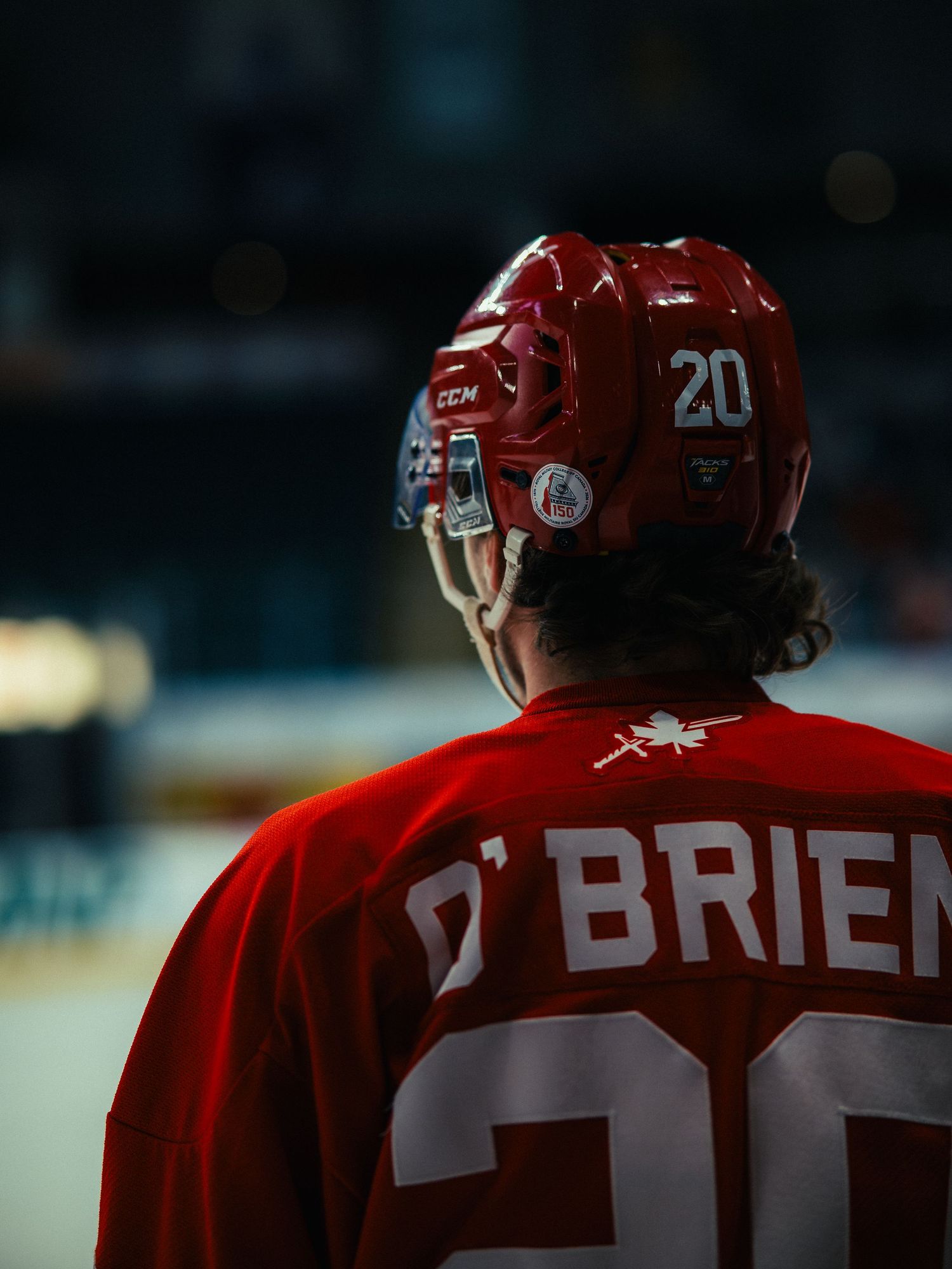 Hockey player wearing red jersey number 20 with O'Brien on the back during a game.