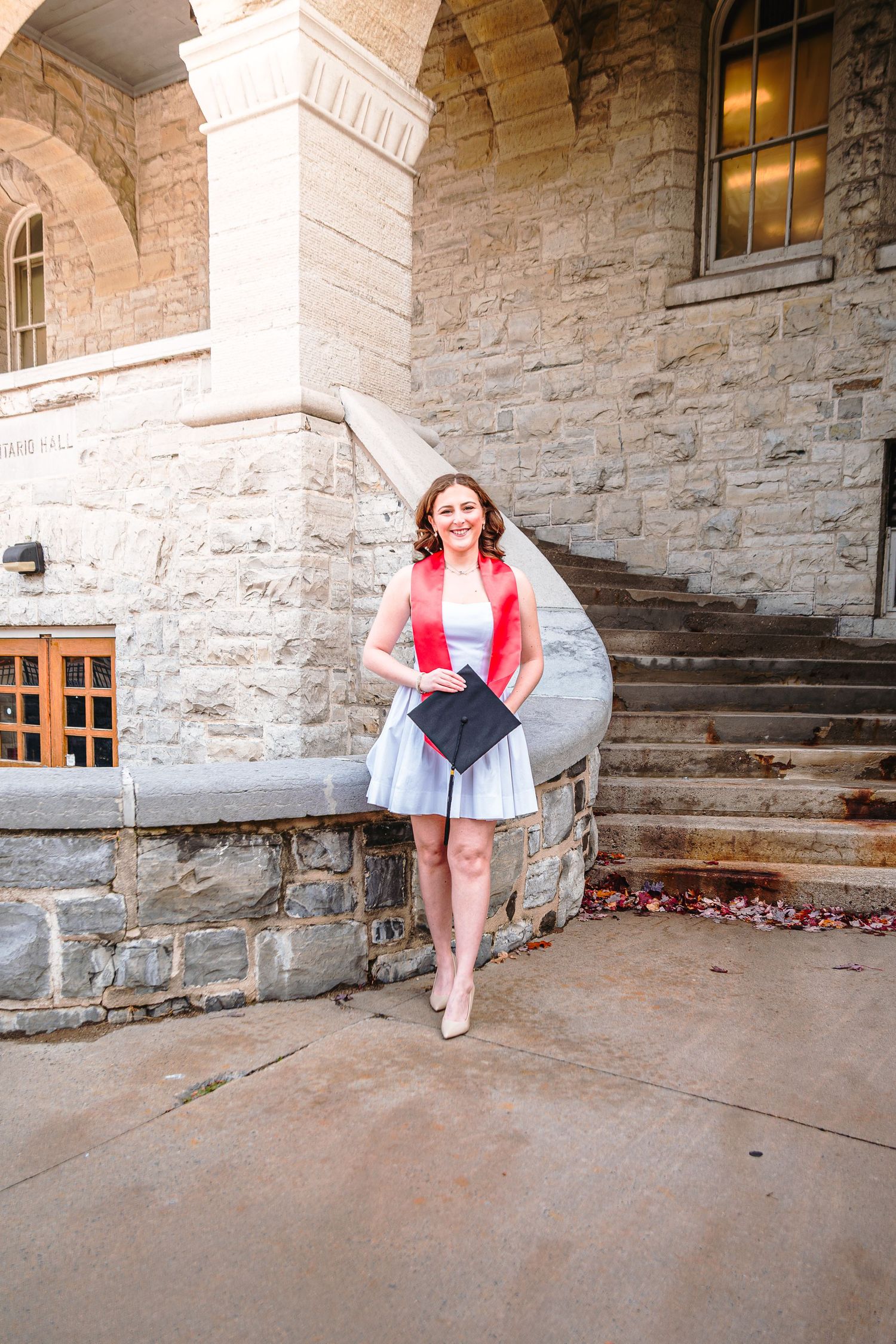 A series of four photos showing someone sitting on stone steps outside a historic building with stone walls.