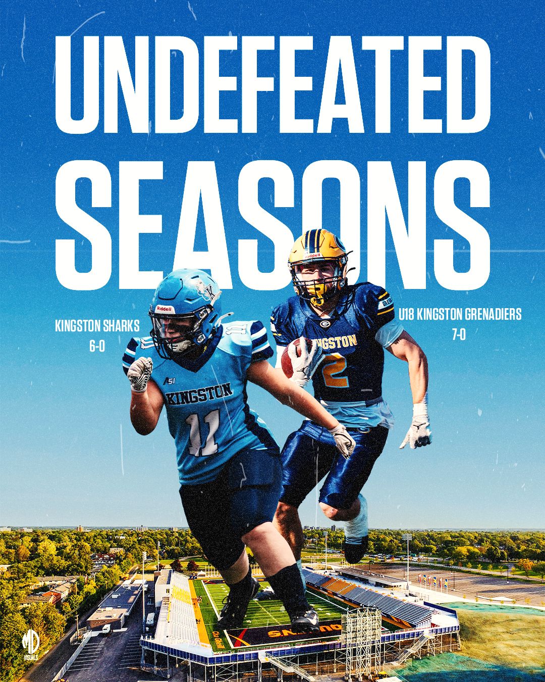 High school football players in blue uniforms practice on field with rural landscape and buildings in background.
