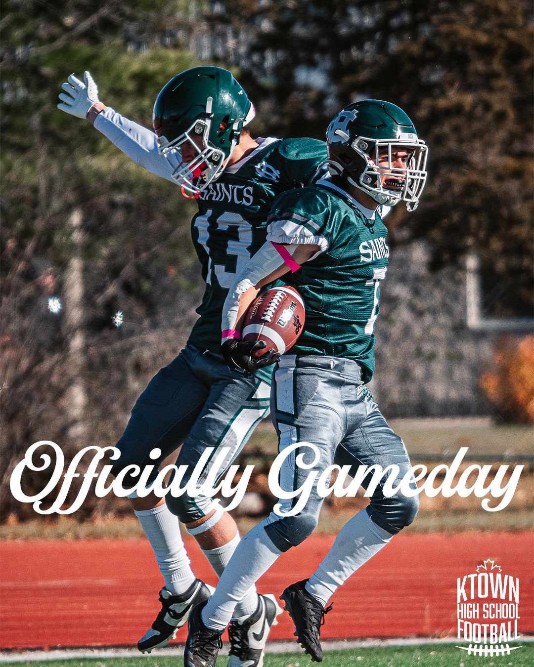 Football players in green jerseys practicing defensive plays on a sunny autumn day at the stadium field.