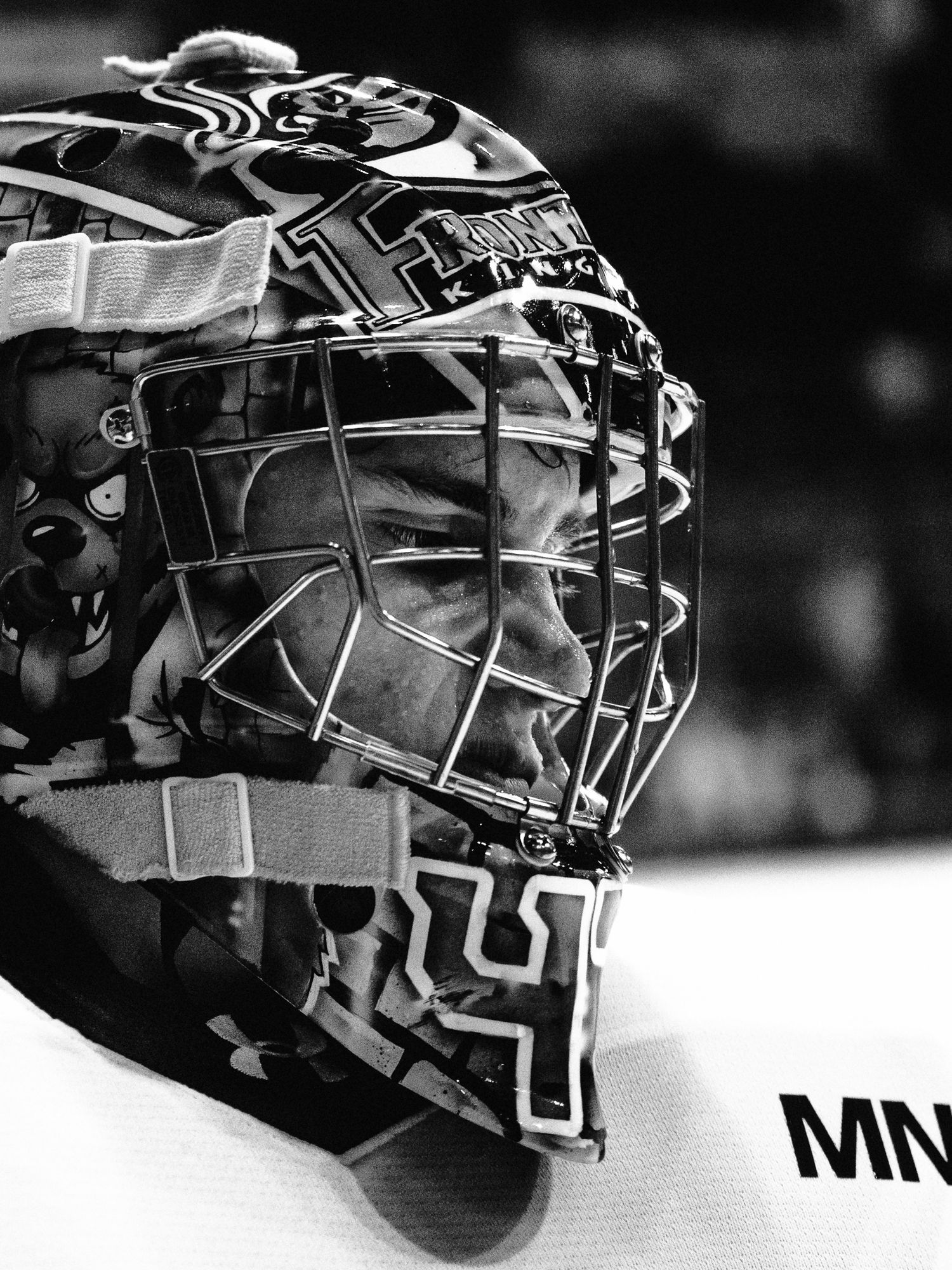 Close-up black and white photo of hockey goalie mask showing detailed cage design.
