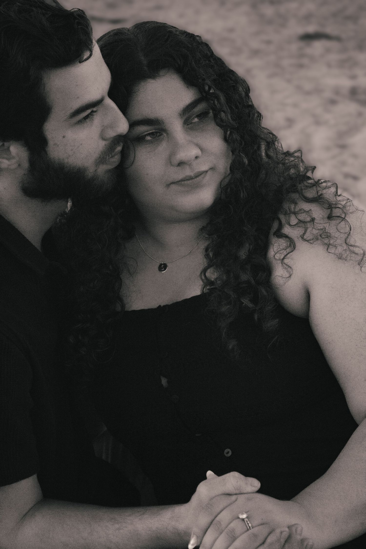 A romantic black and white photo series showing a couple embracing and sharing intimate moments together.