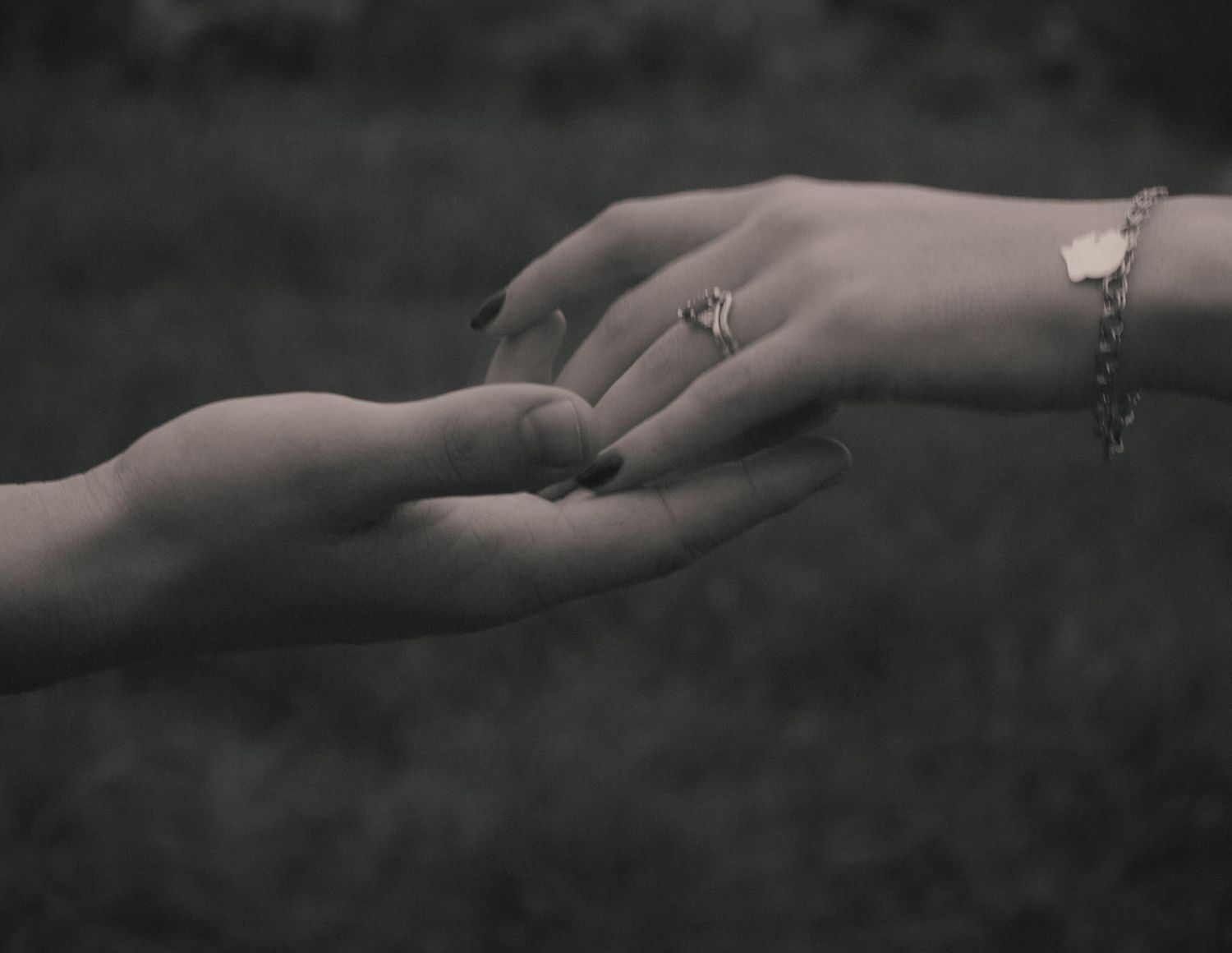 Black and white close-up photo series showing hands with engagement rings in various romantic poses.