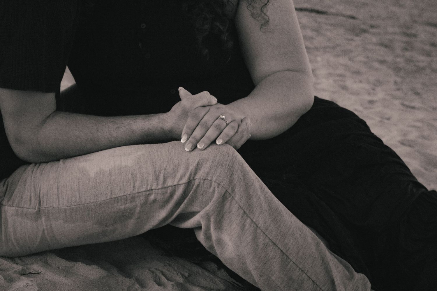 A series of black and white images showing hands resting on fabric in various positions and angles.