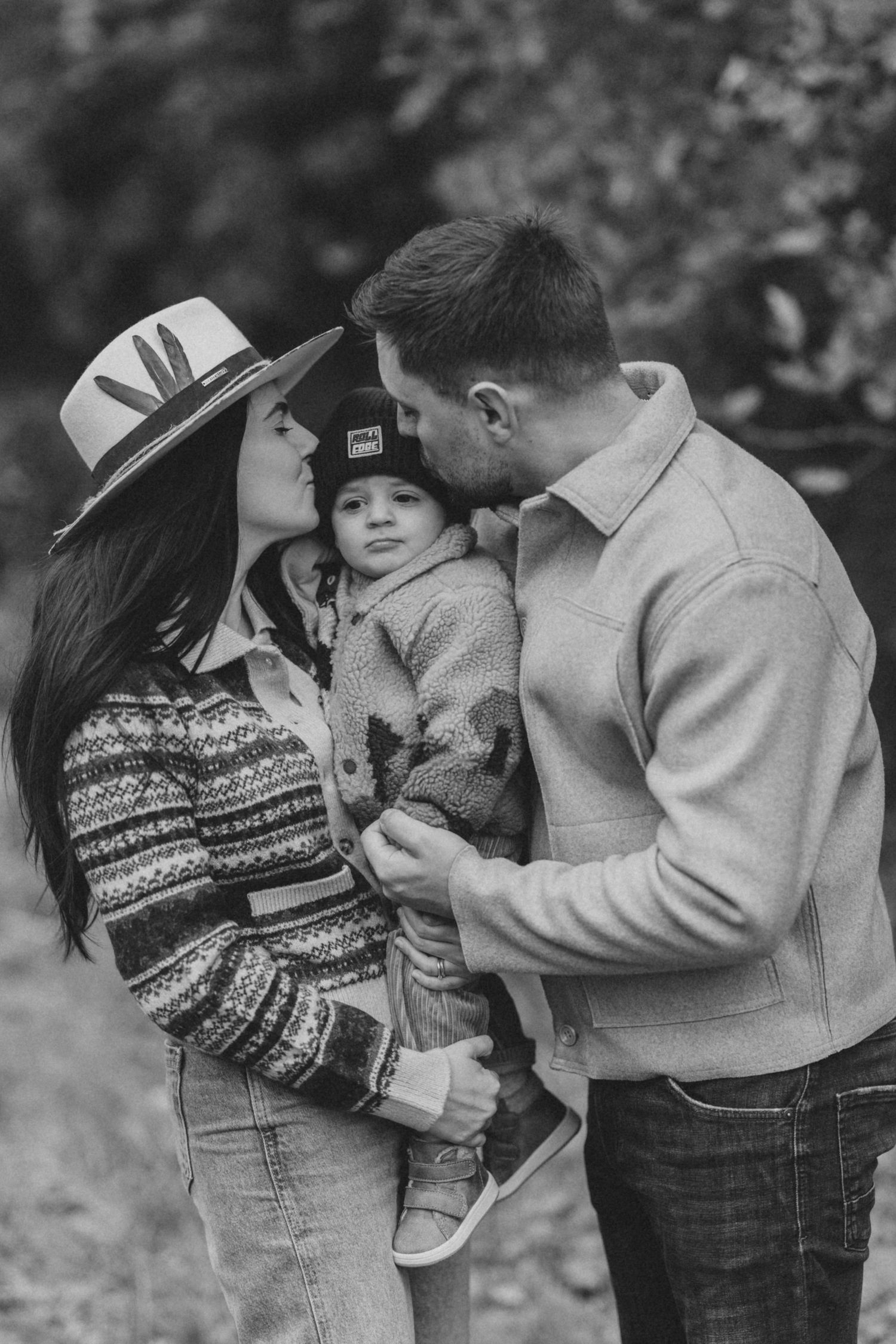 Black and white photo series of couple sharing intimate moments in casual winter attire.