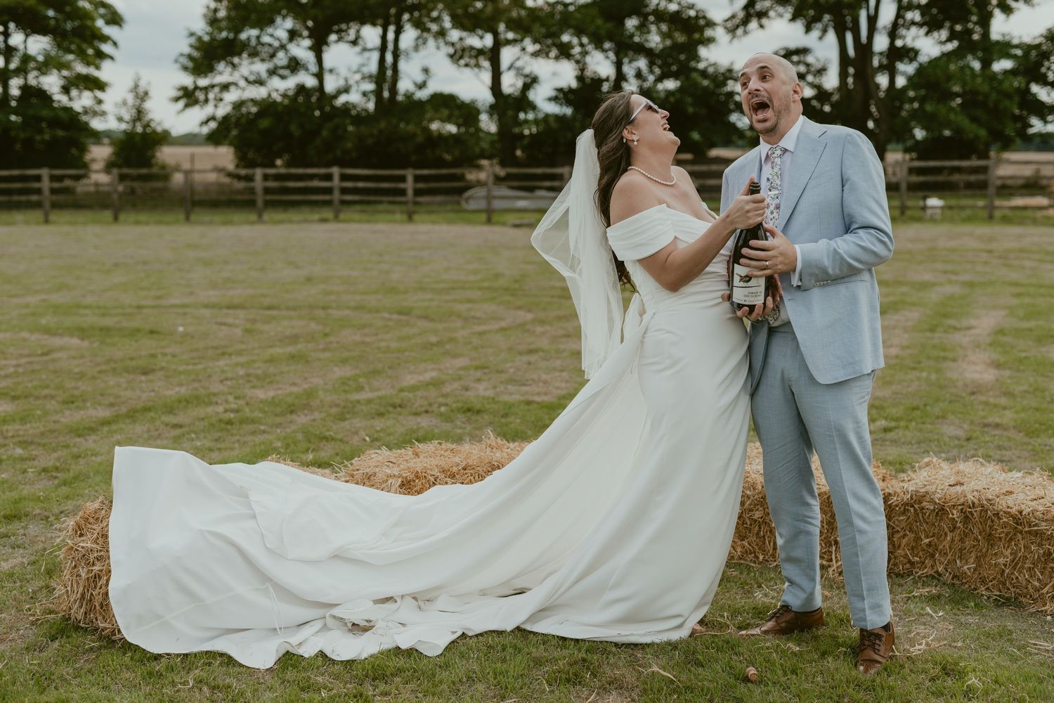 Couple dancing and twirling together on grass with the bride's dress flowing.