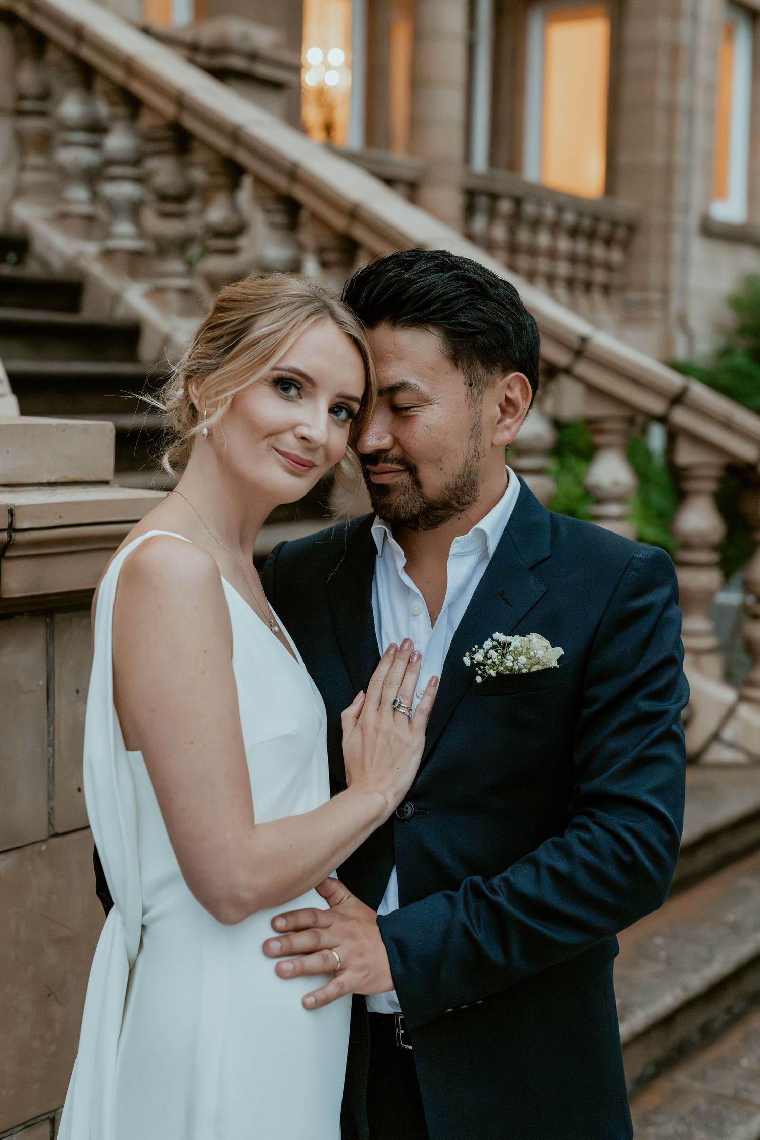 Intimate wedding portraits on brownstone steps showing tender romantic moments.