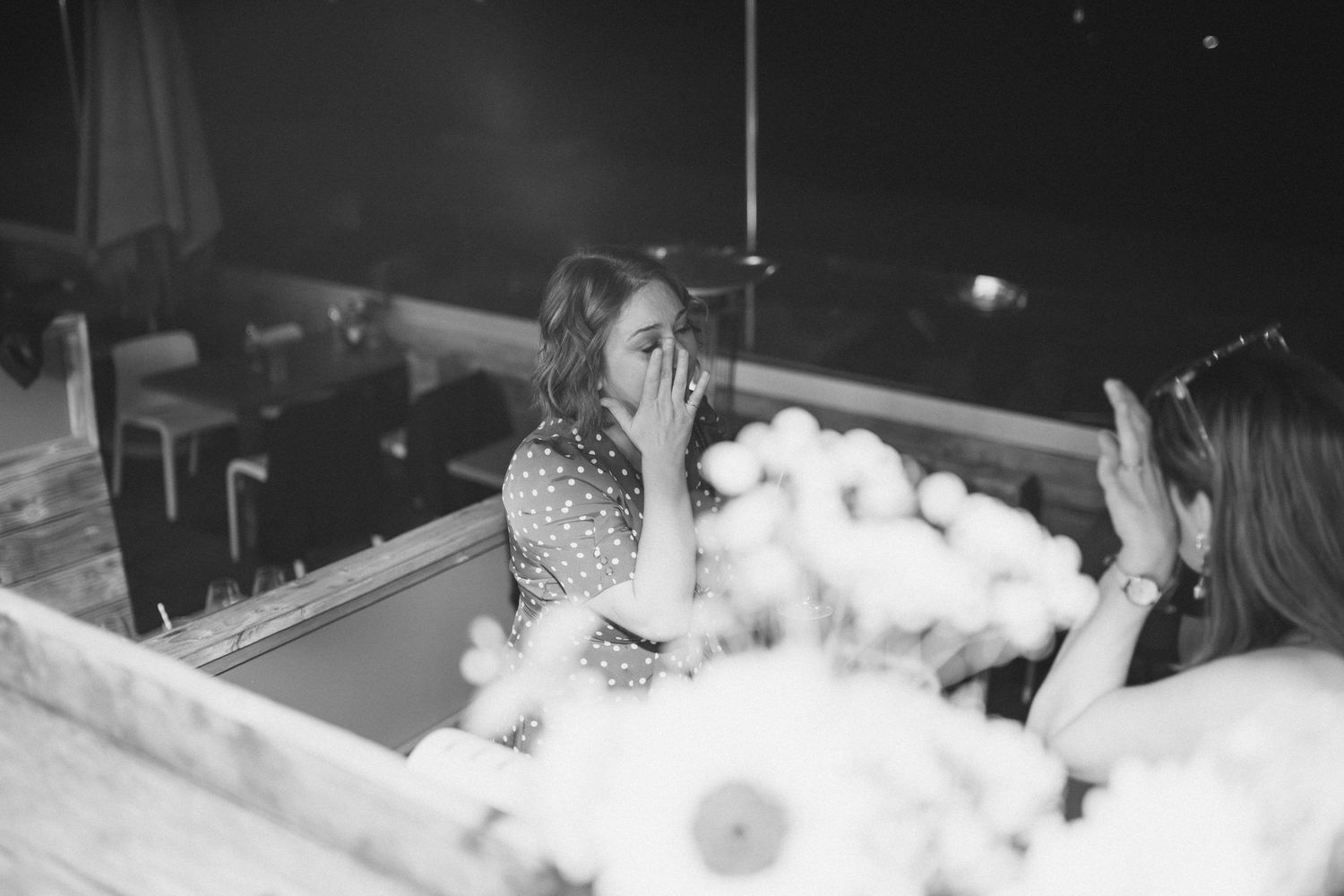 Blurry black and white party scene with dancing figures and atmospheric lighting.