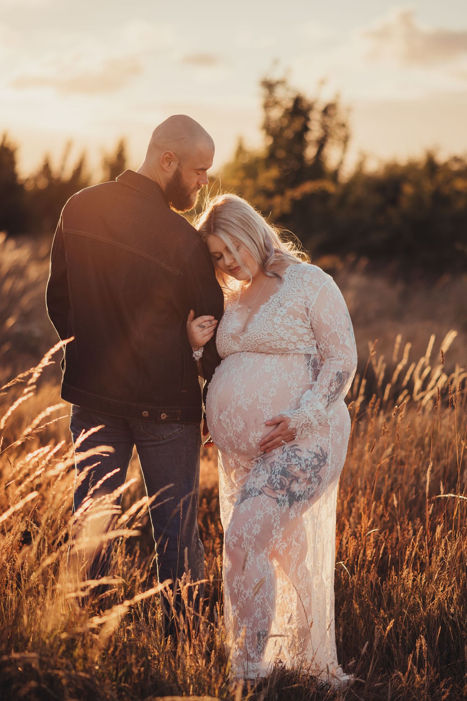 Romantic sunset portrait in tall grass with warm golden lighting.