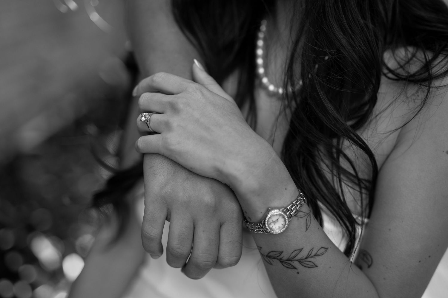 Close-up detail shots of hands and jewelry in an intimate black and white photo series.