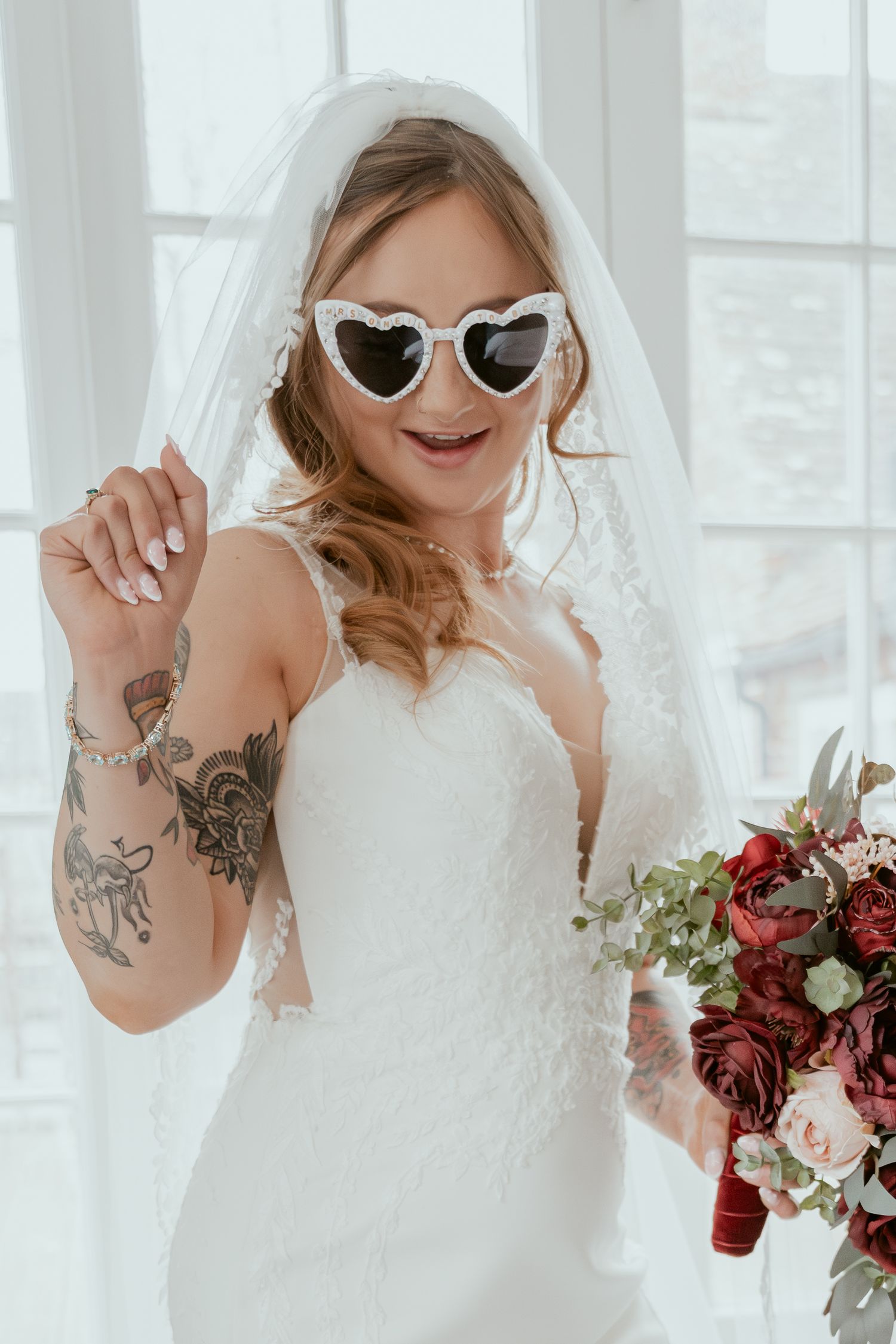 Three close-up photos show a bride in a lace wedding dress with sunglasses and tattoos posing playfully.