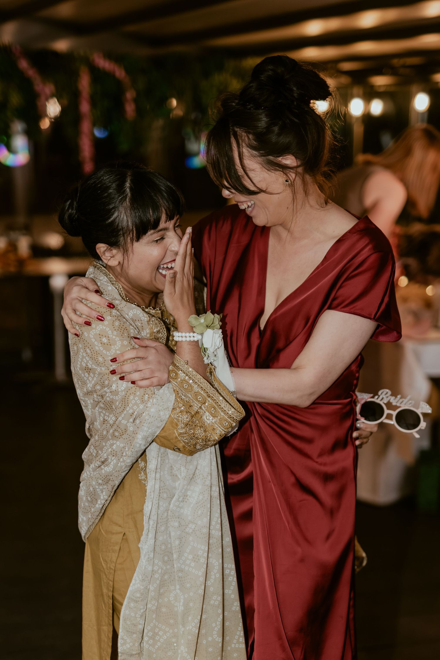 Intimate dance moments at reception with burgundy and gold formal attire.