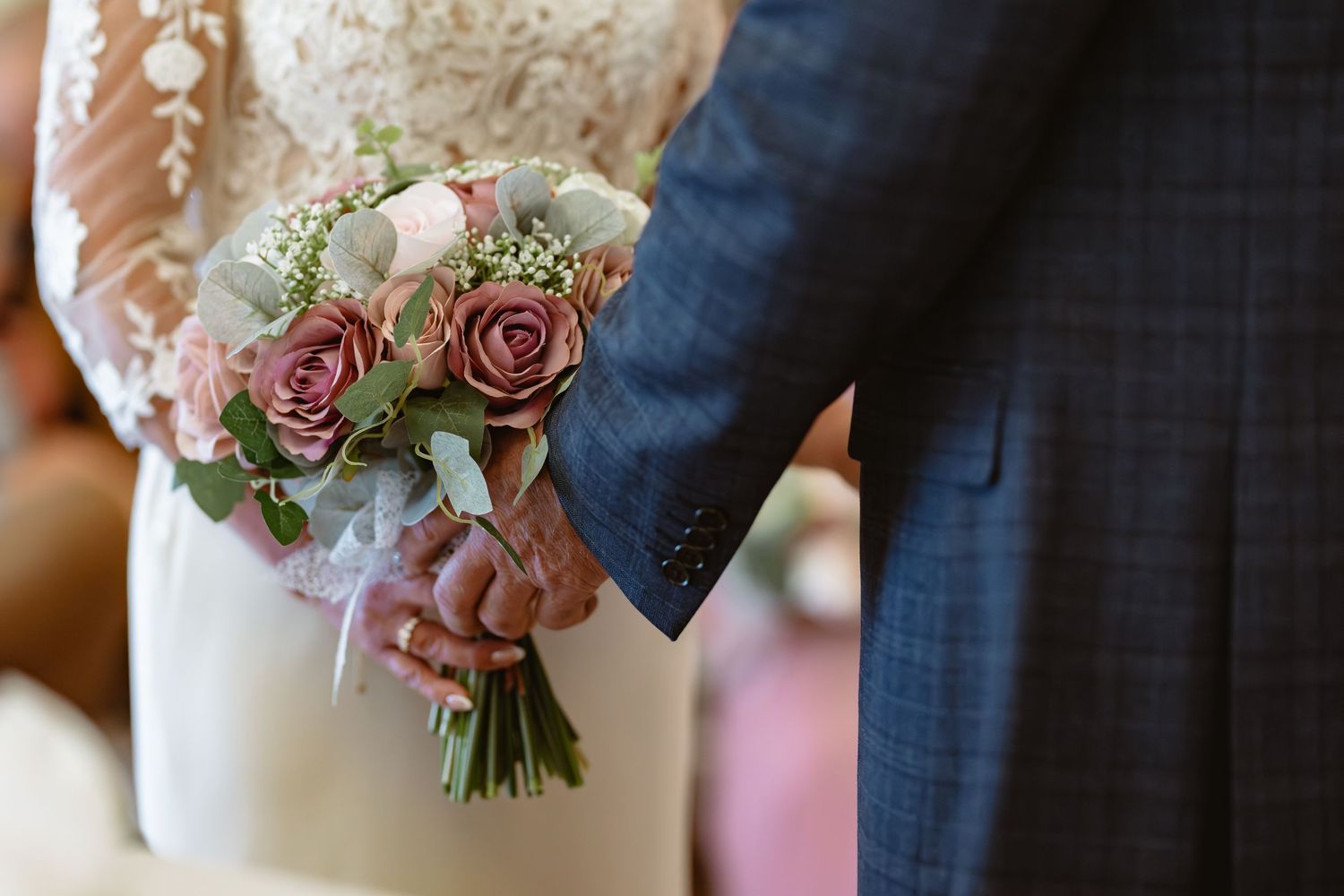 Delicate pink and rose wedding bouquet with vintage lace details.