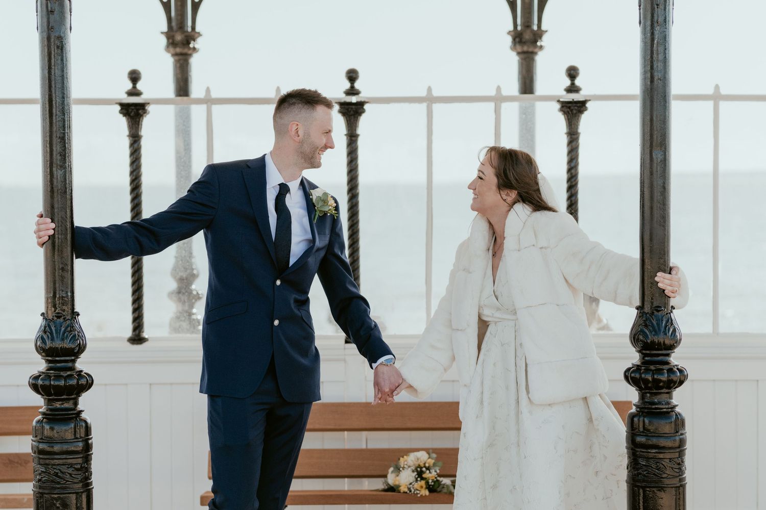 A couple shares a romantic moment in a Victorian seaside pavilion.