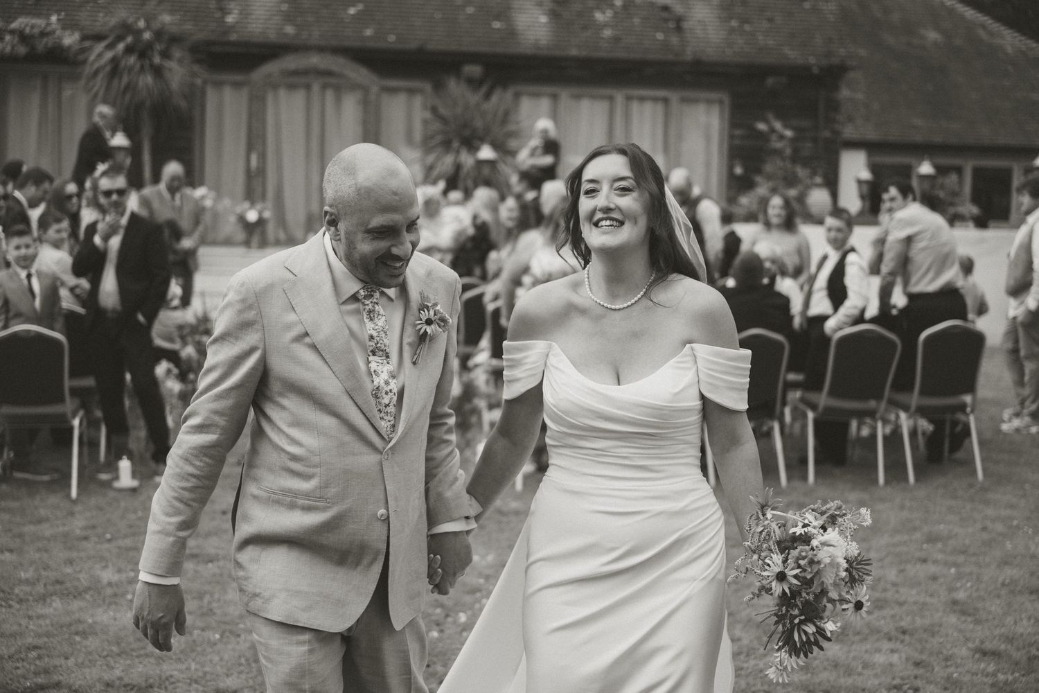 Black and white photos of a joyful wedding celebration on a lawn.