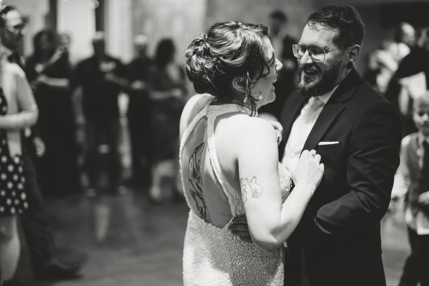 Black and white photos capture dancing couples at a wedding reception.
