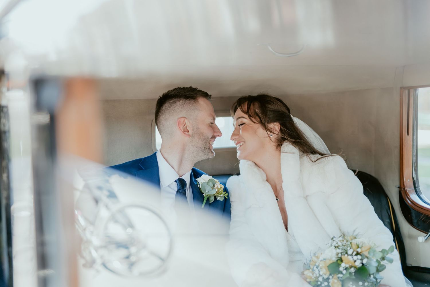 Wedding ceremony moments captured in an elegant indoor setting with floral arrangements and romantic lighting.