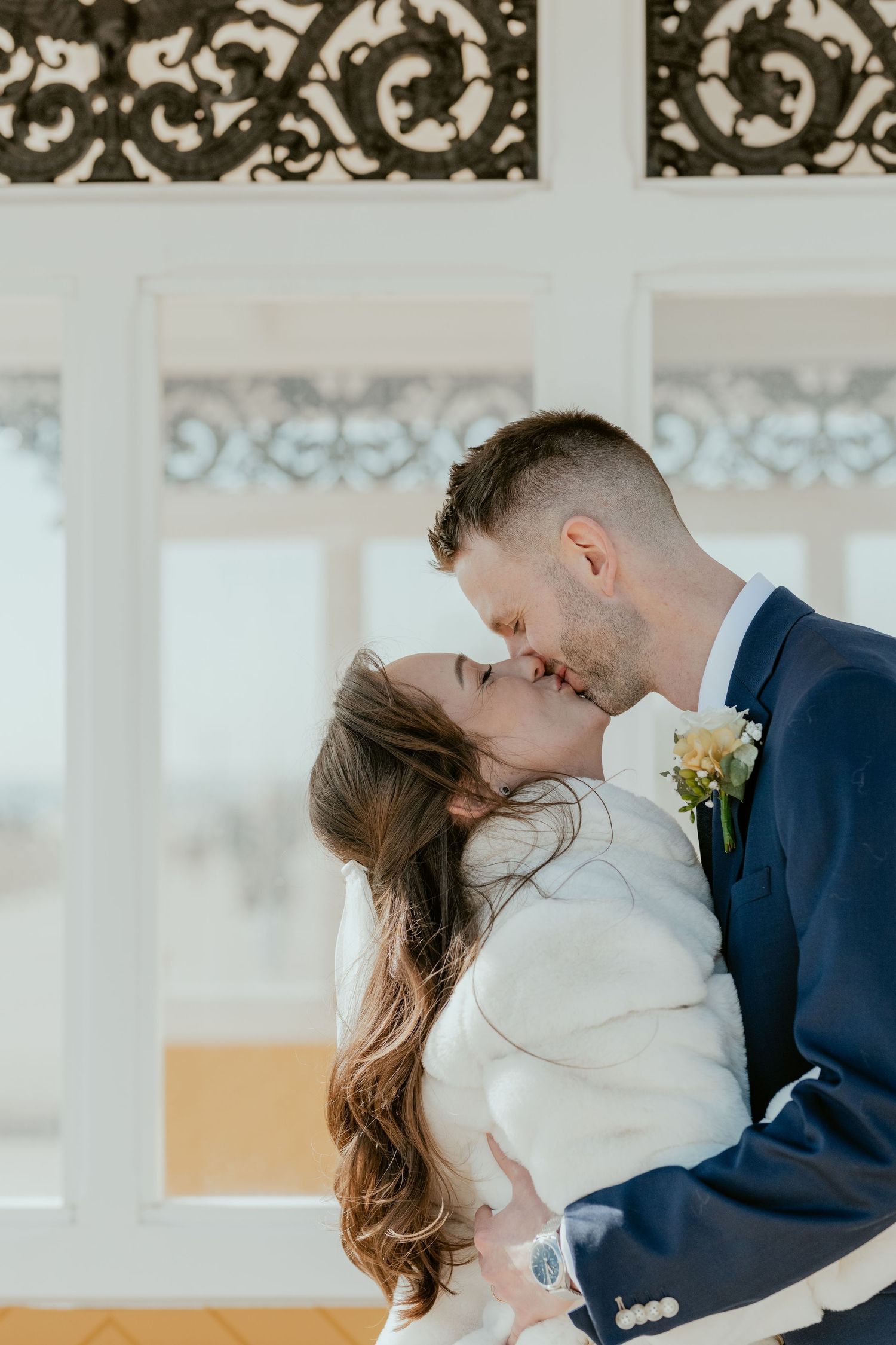 A tender moment shared under an ornate Victorian shelter.