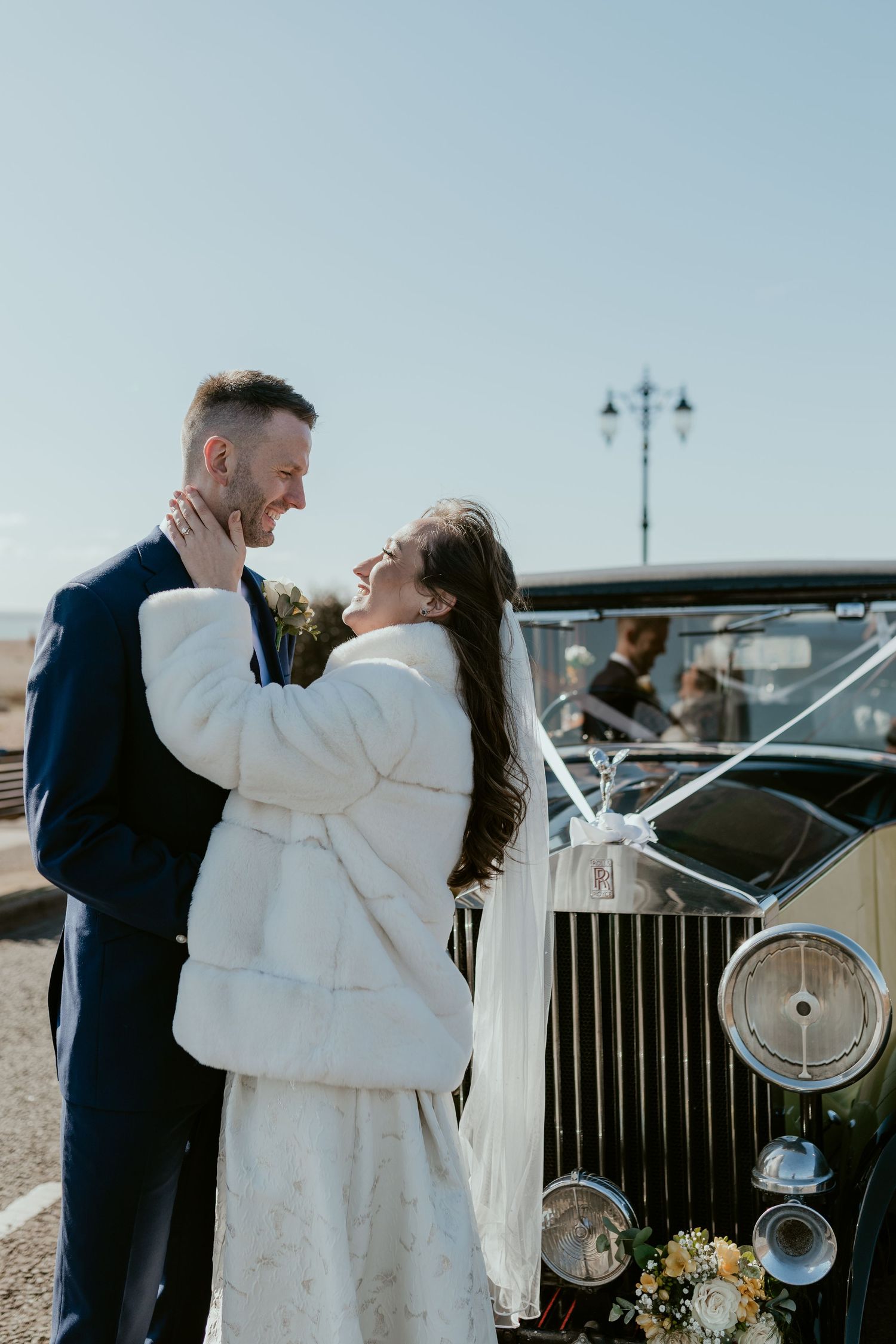 A romantic moment captured between a couple in winter wedding attire.