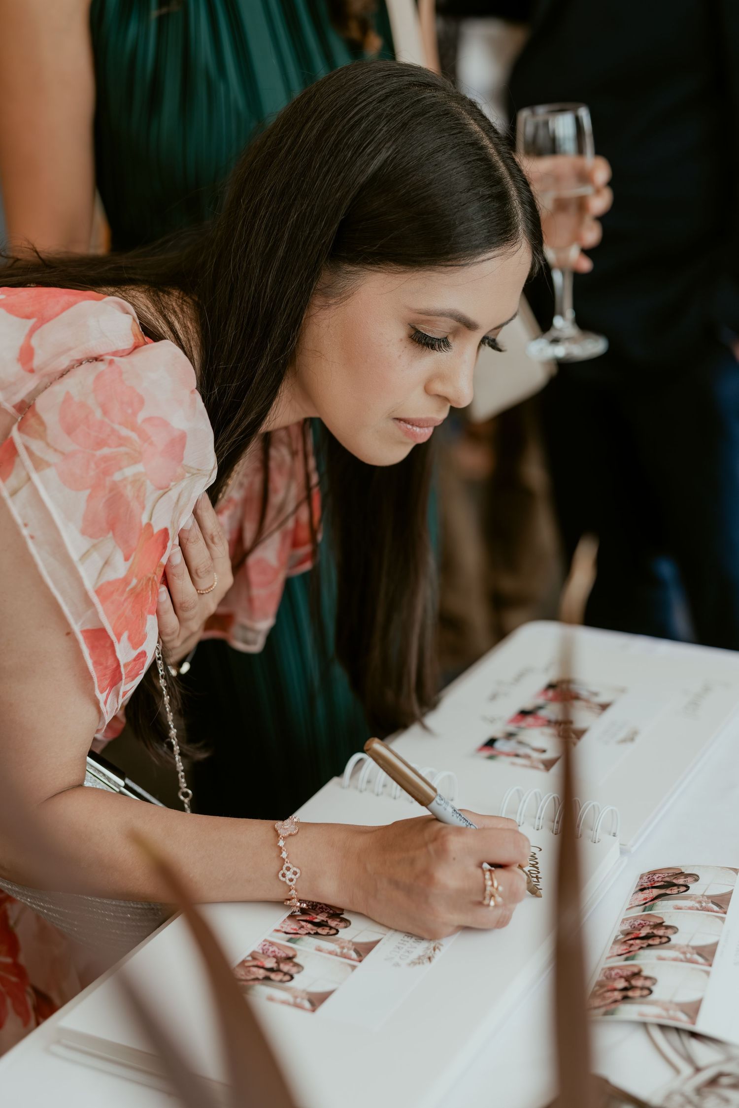 A series of photos showing someone signing a wedding guestbook at a celebration.