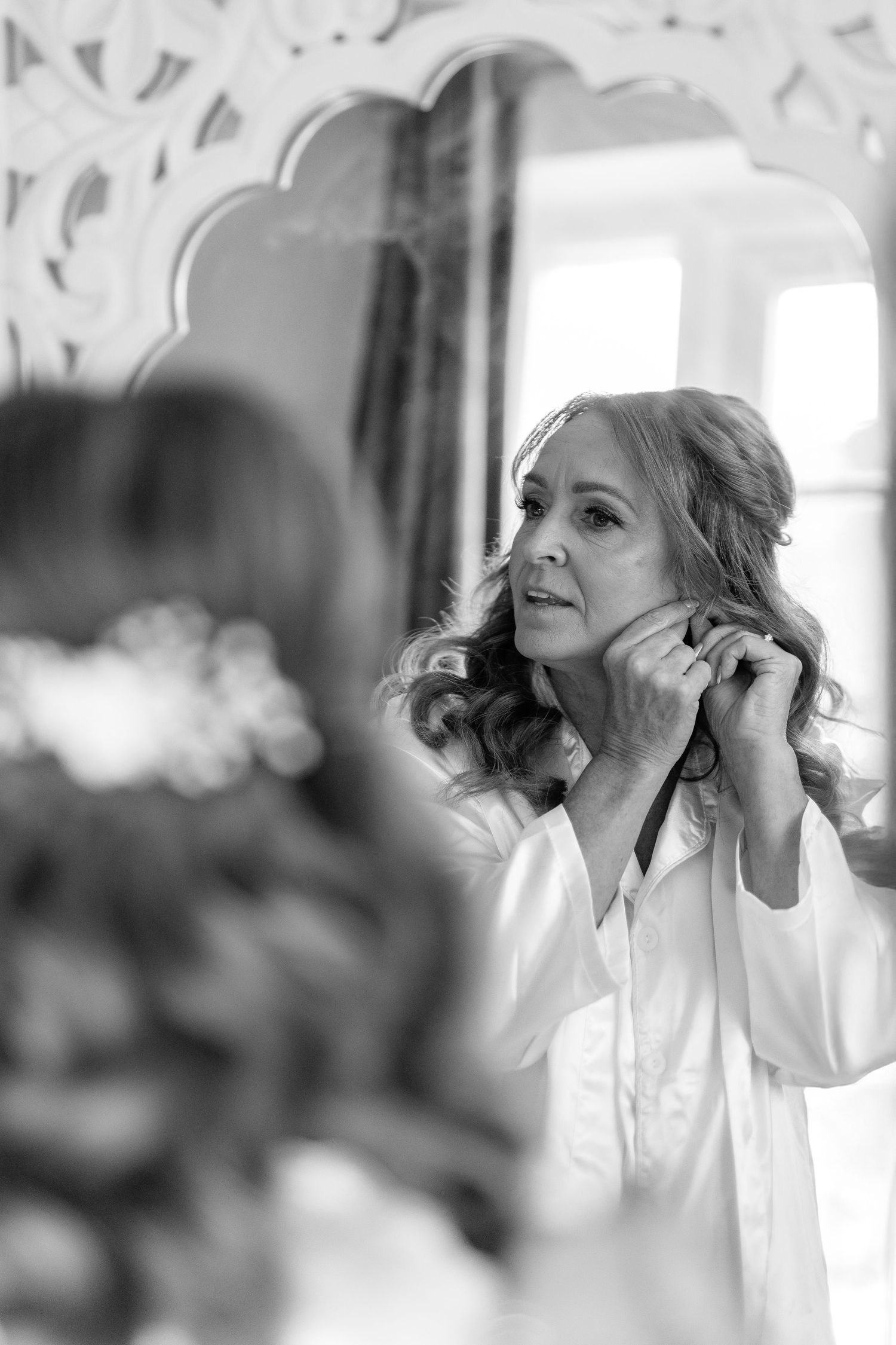 Black and white getting ready photos showing final wedding preparations.