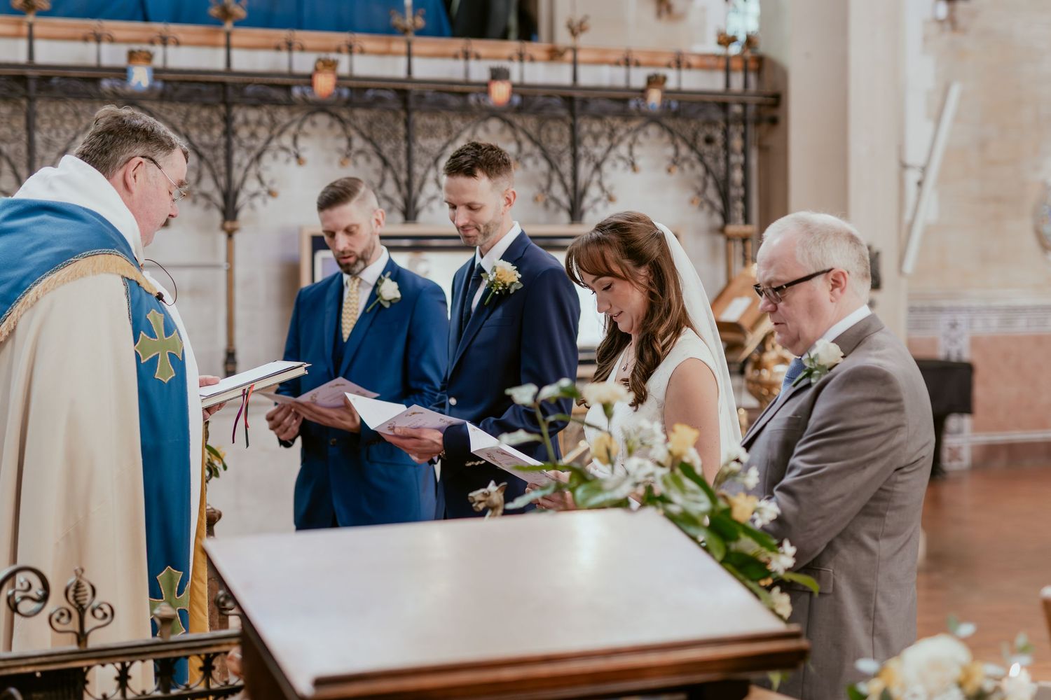 Panoramic view of a church wedding ceremony with elegant decor and natural lighting.