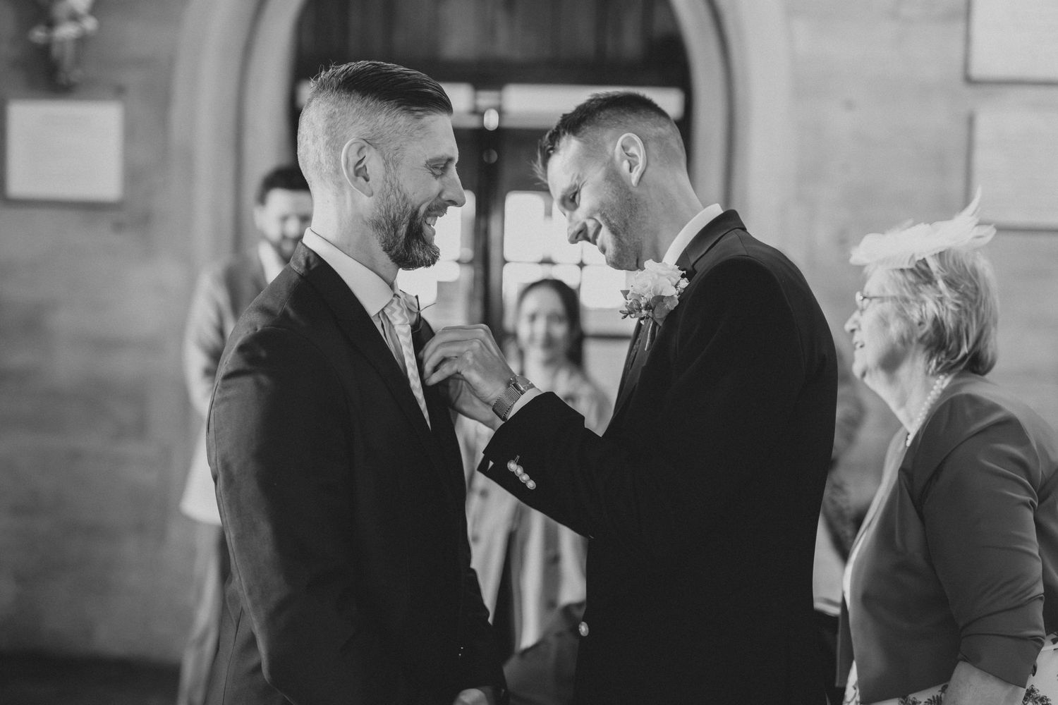 Intimate wedding ceremony moments captured in black and white showing emotional exchanges at the altar.