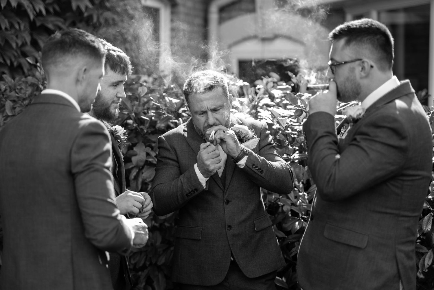 Wedding party laughing and celebrating together outdoors in formal attire.