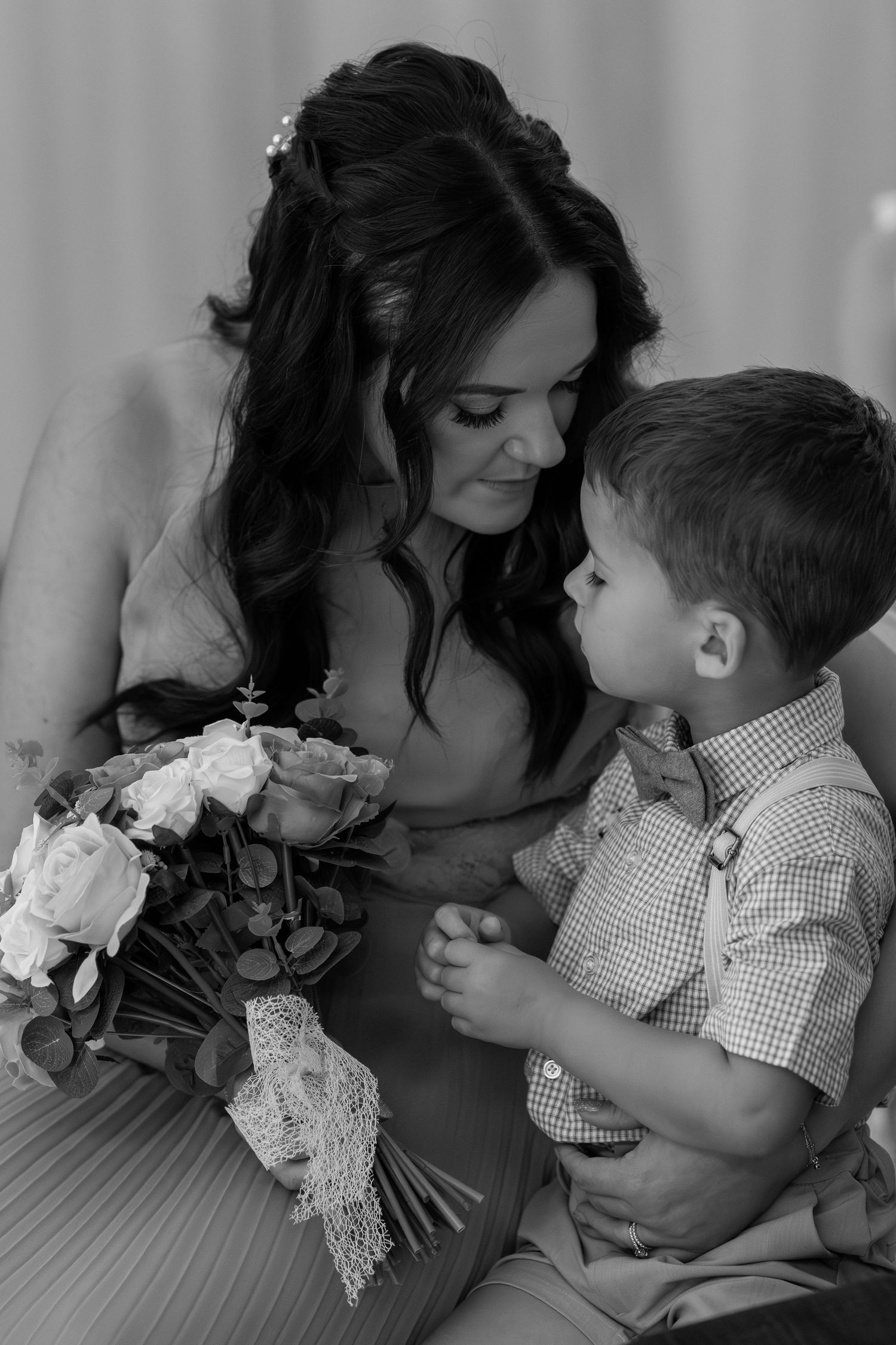 Black and white intimate photos showing tender moments between mother and young child.