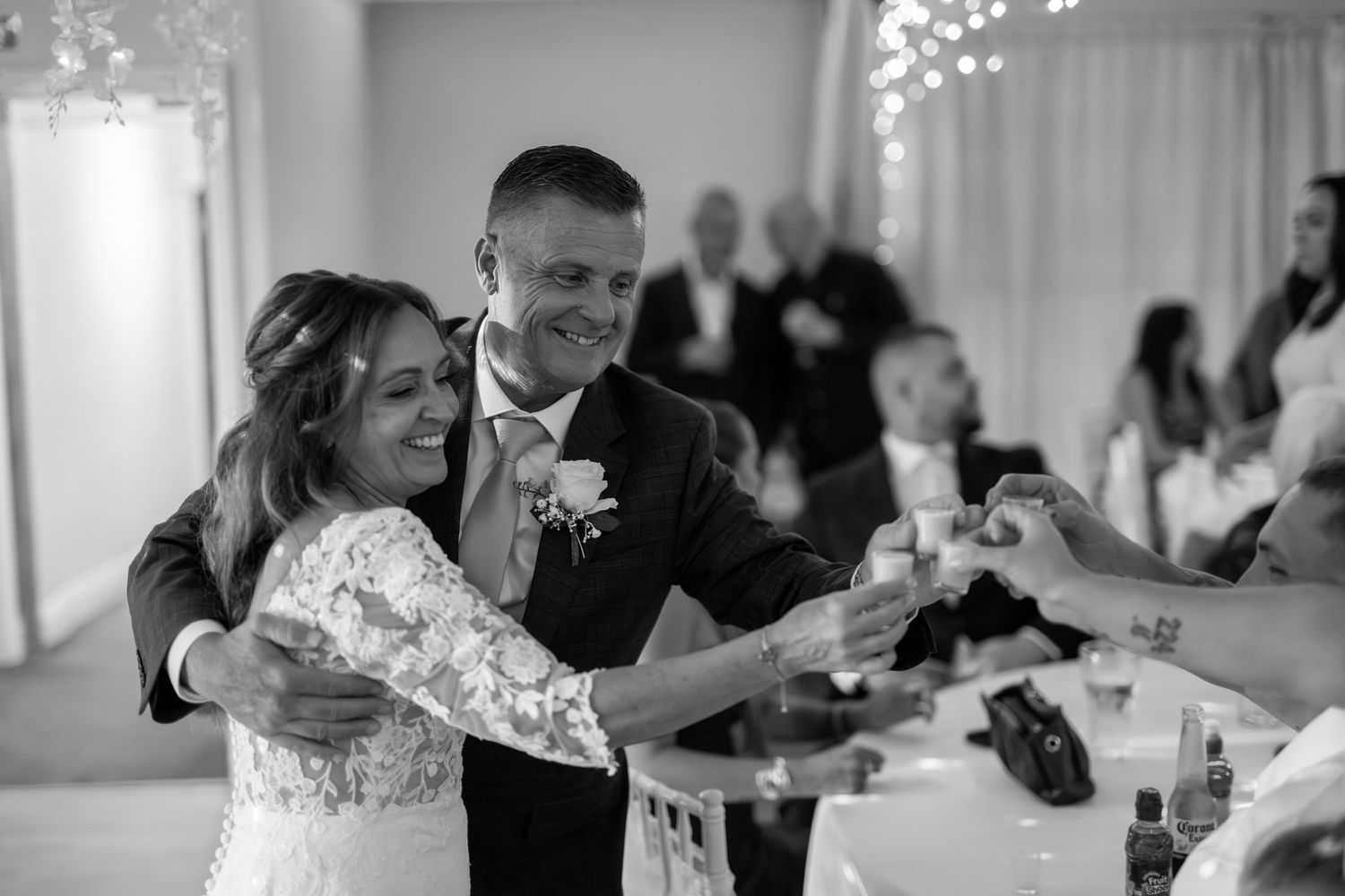 Wedding reception dance floor filled with guests enjoying themselves under twinkling lights.