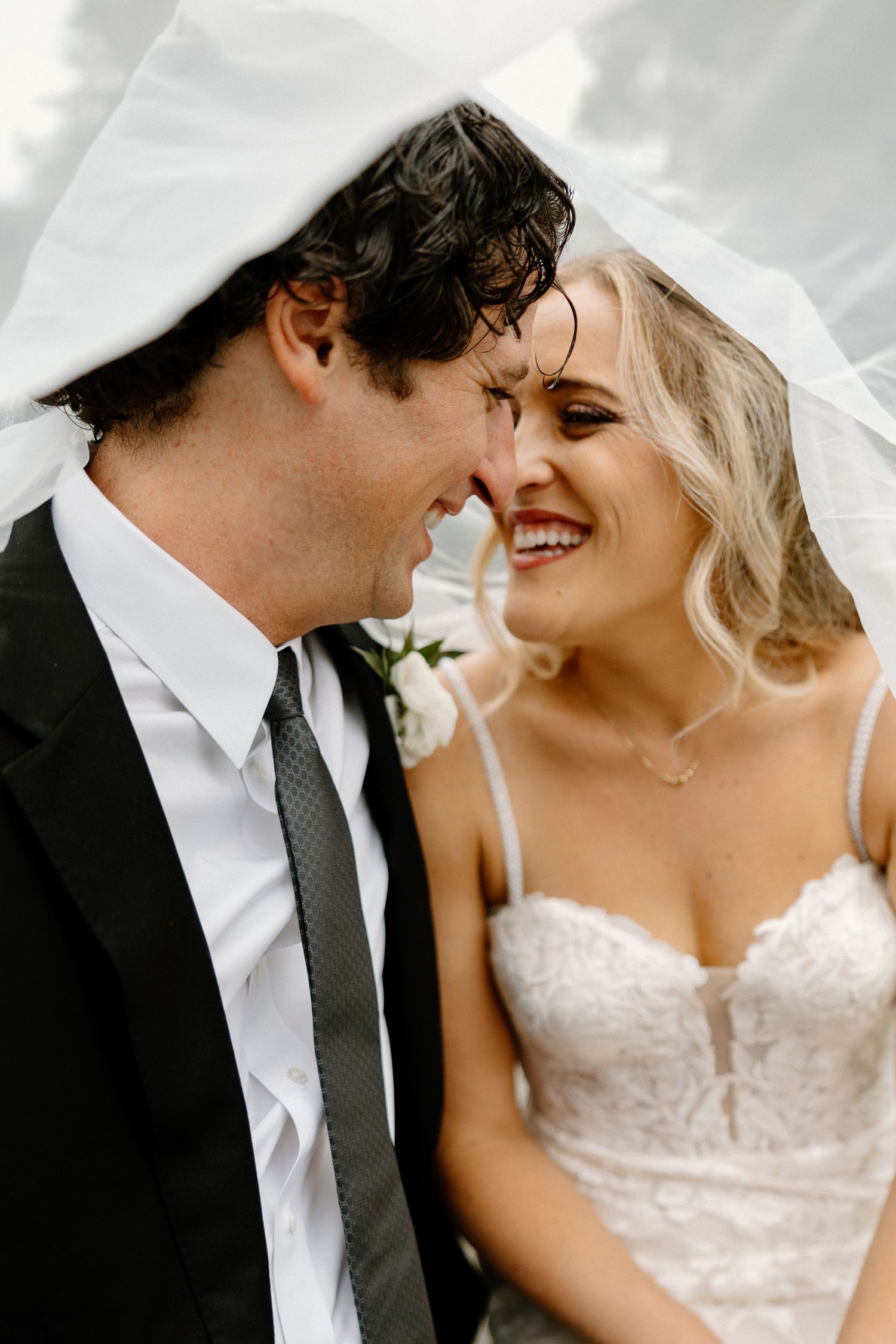 Close-up wedding portrait showing tender moments between bride and groom.