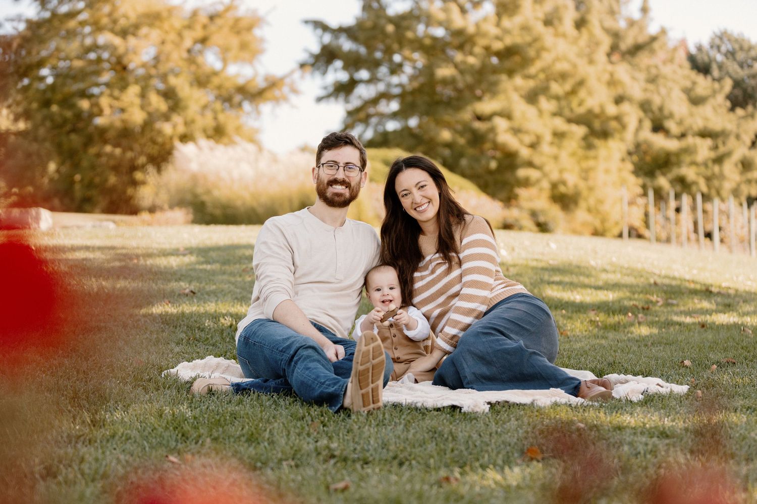 Romantic couples photography session in a sun-drenched field during golden hour.
