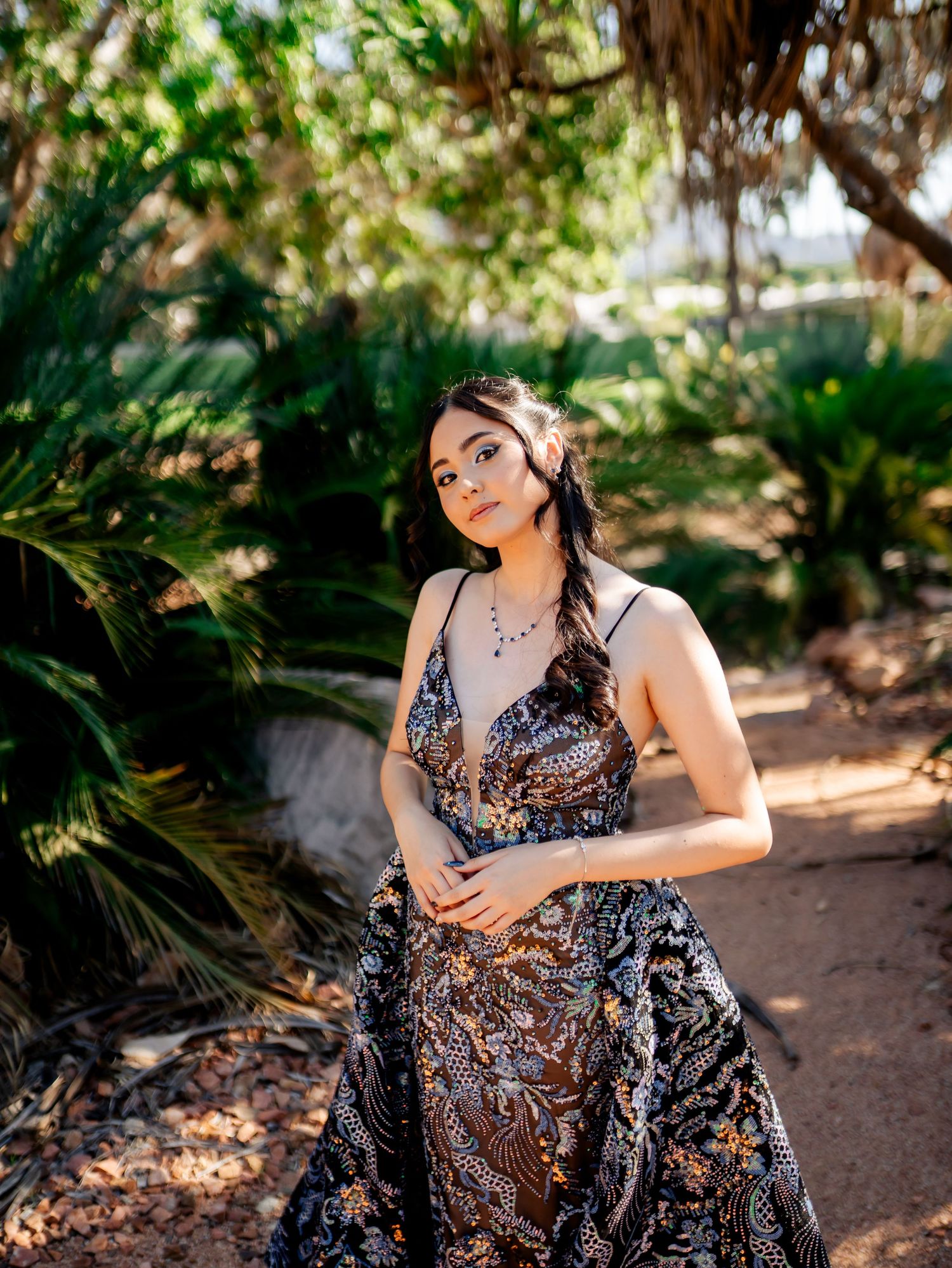 Glamorous portrait session in tropical garden setting with sparkly formal gown.