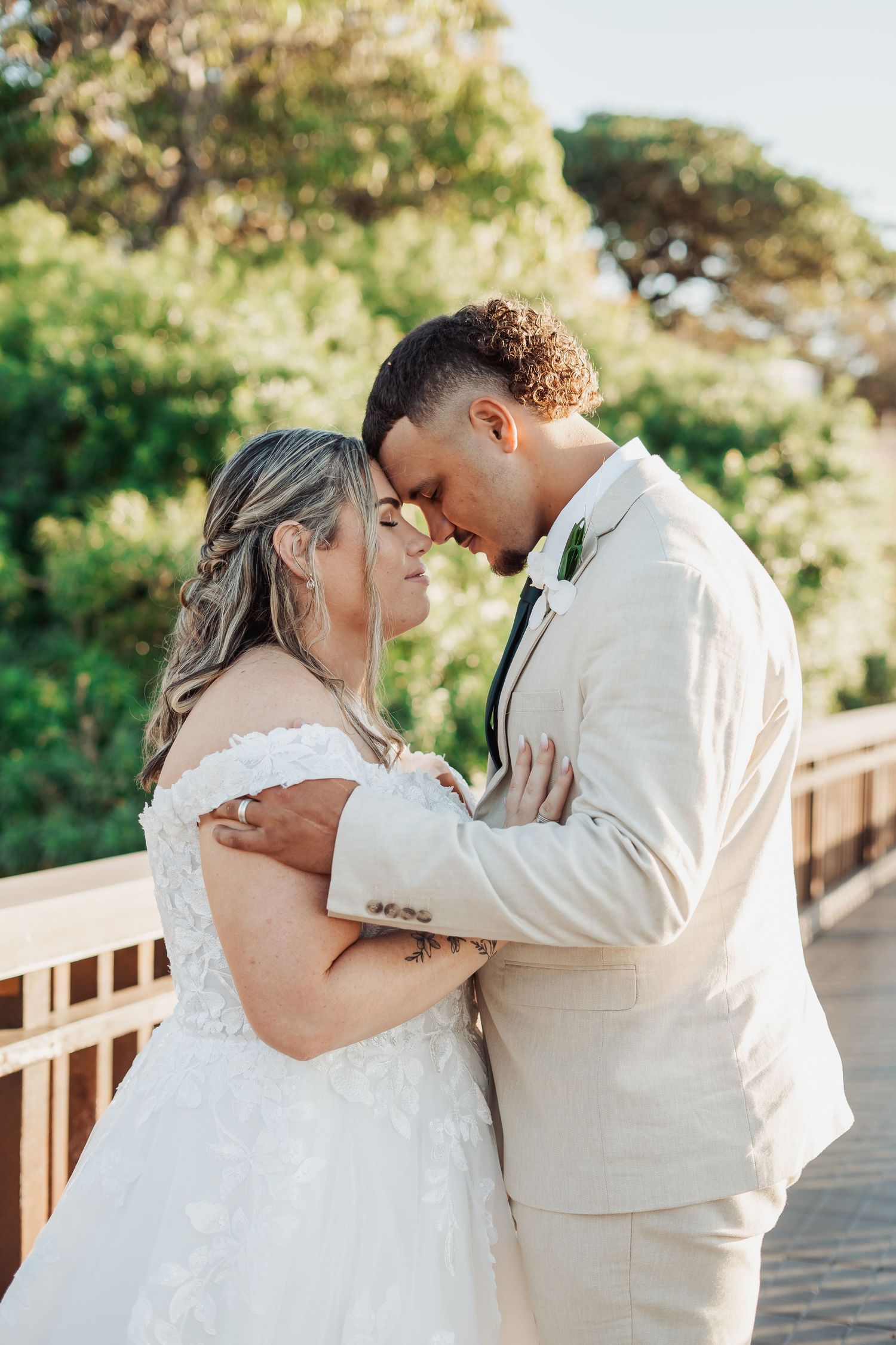 Romantic couple shares intimate moments in a series of wedding photos on a wooden bridge during golden hour.