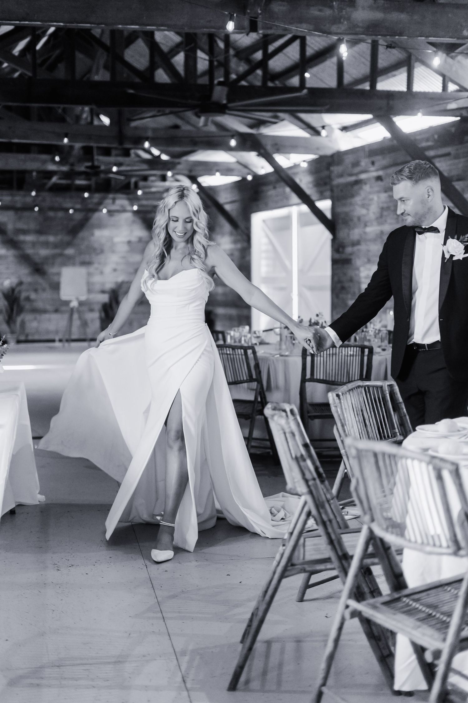 Dramatic black and white wedding dance sequence in industrial venue.