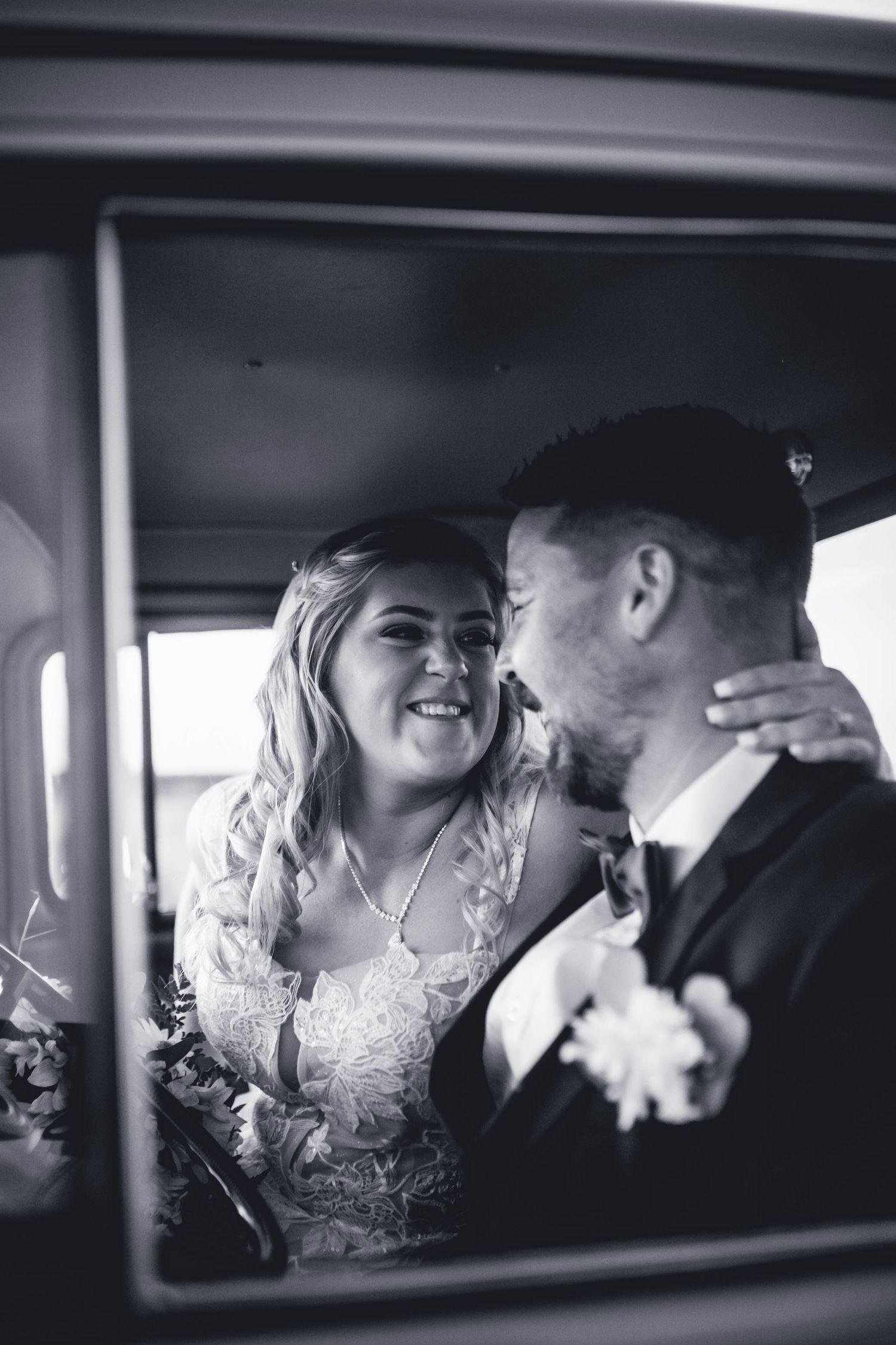 A romantic moment captured through a vintage car window on a wedding day. Long Horns Charters Towers