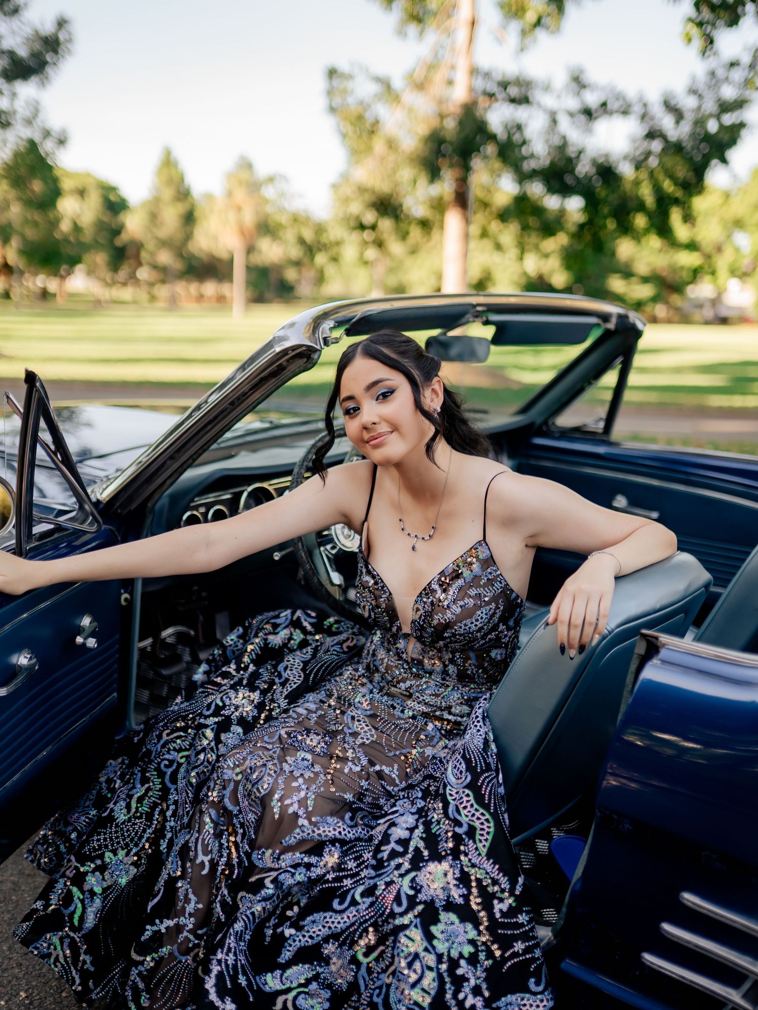 Elegant portrait session featuring a sparkly gown and classic convertible car.