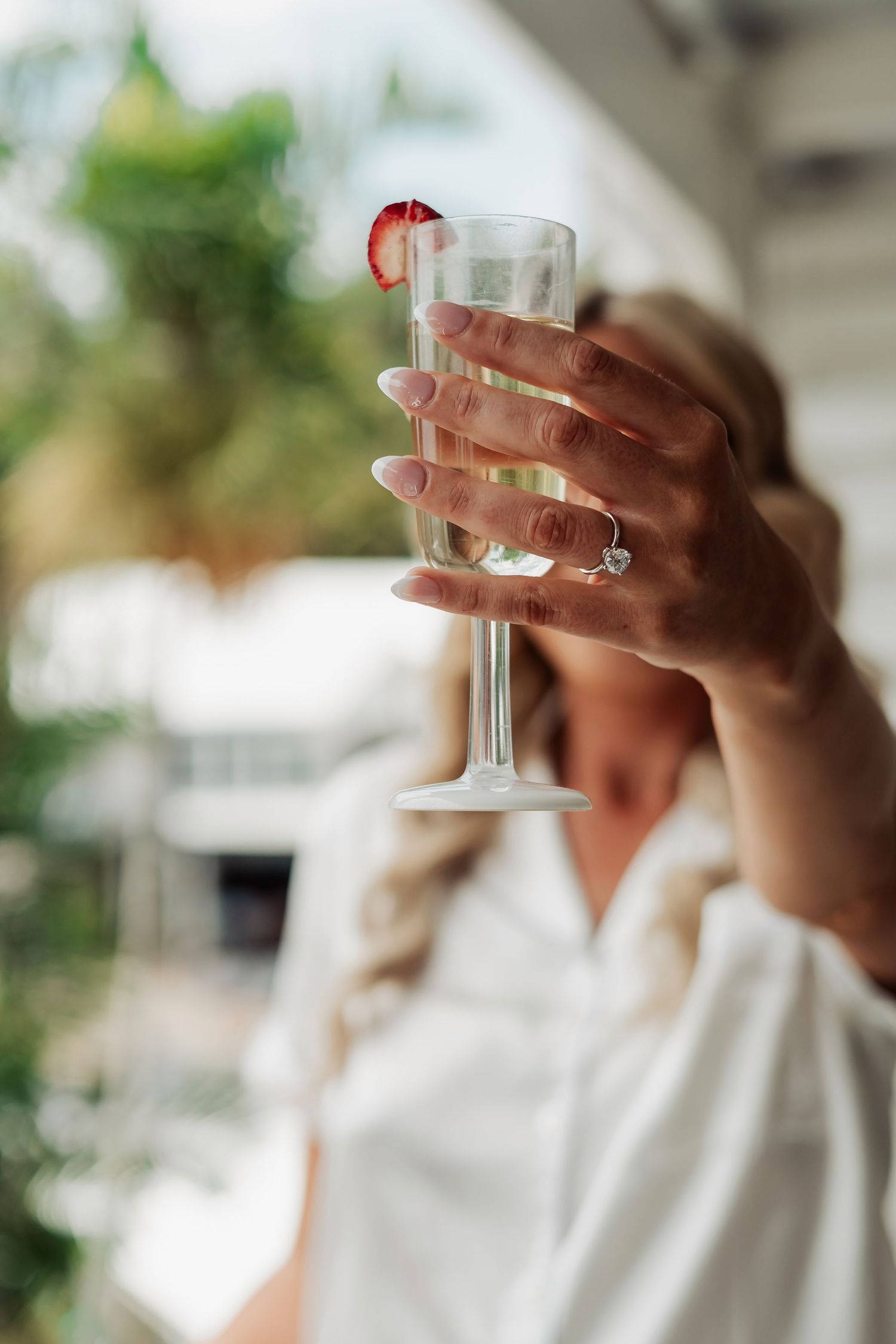Hands holding champagne glasses in elegant wedding day celebration.