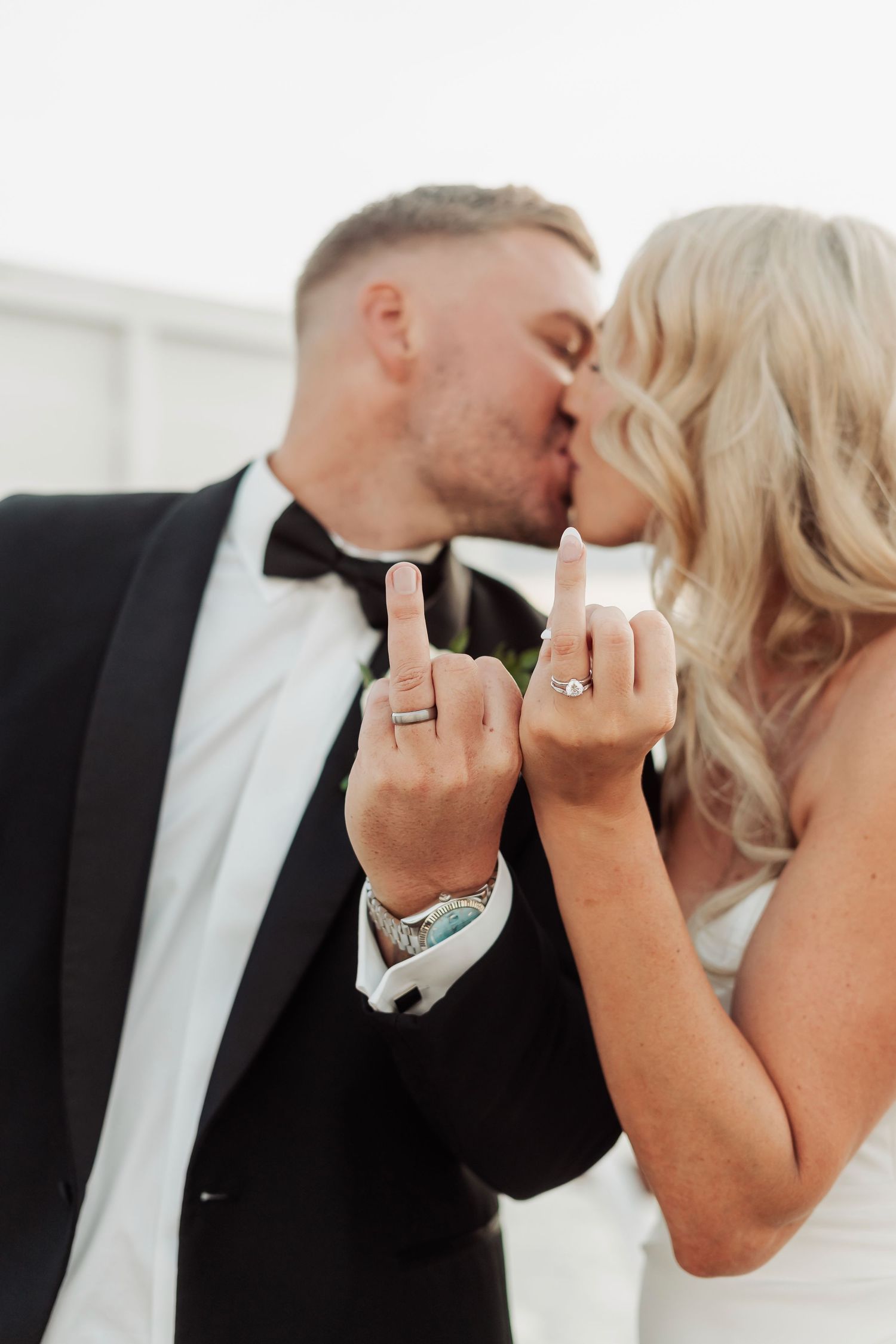 Close-up shots of newlyweds kissing while showing off their wedding rings.